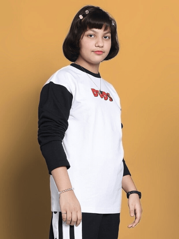 Child wearing a white oversized sweatshirt with black sleeves and 'DUDS' logo, designed for boys and girls by experienced tailors.
