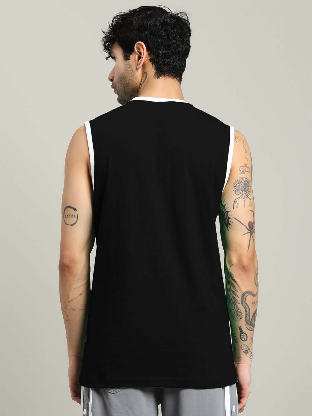 Rear view of a man wearing a black 'Me Vs Me' gym t-shirt from DUDS, showcasing the sleek design and fit.