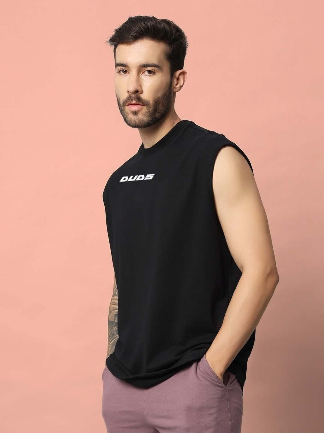Man wearing Backbone Gym T-Shirt in black by DUDS, offering customizable size options and handmade quality.