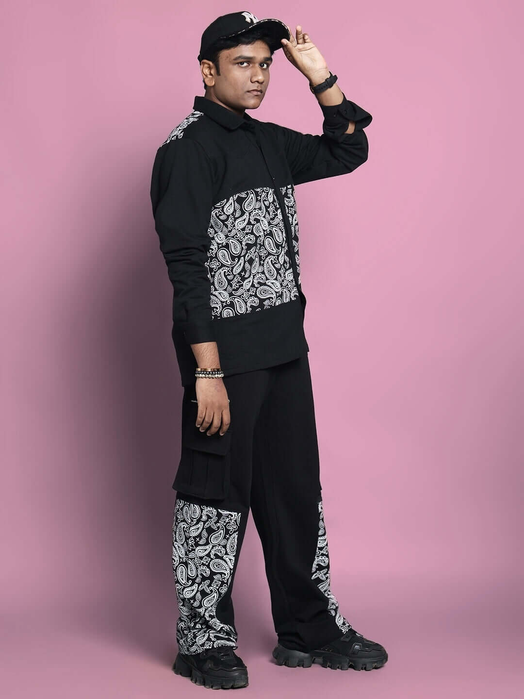Person wearing COVE COTTON TERRY CO-ORD SET BLACK BANDANA PRINT with pink background.