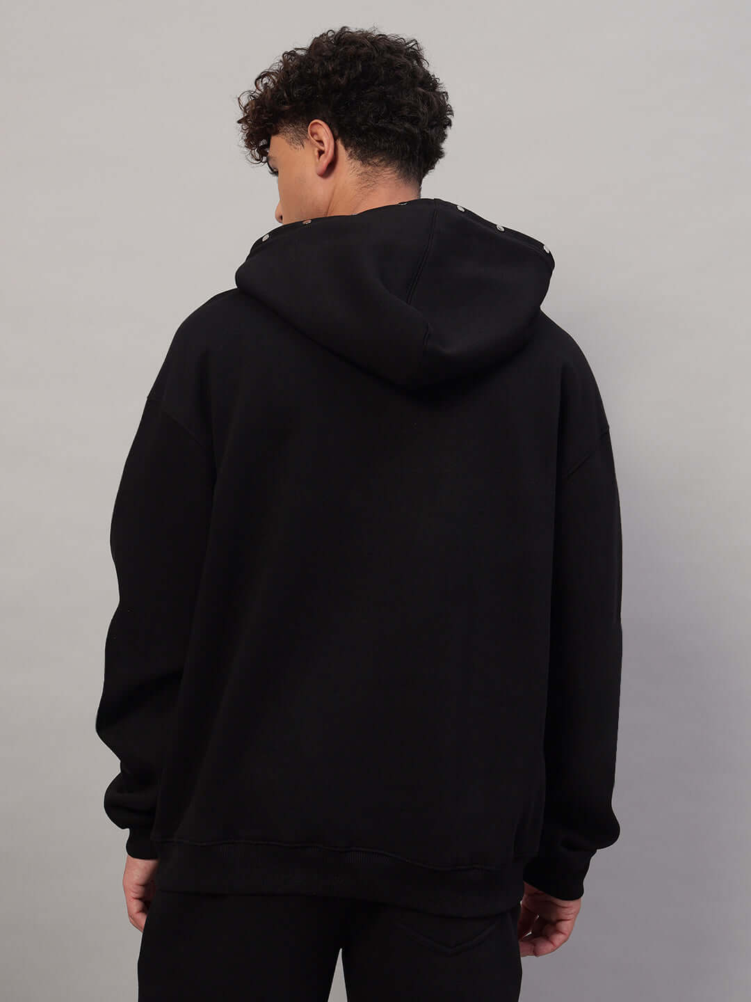 Rear view of WEARDUDS RIGID FLEECE HOODIE BLACK, showcasing hoodie style