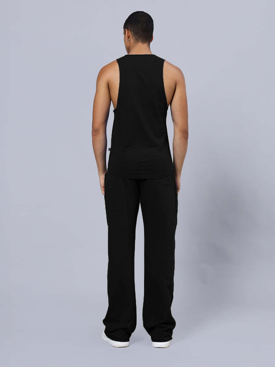 Back view of model wearing ANIMAL PRINTED RELAXED FIT CO-ORD SET BLACK with joggers and tank top, showcasing elastic waistband.