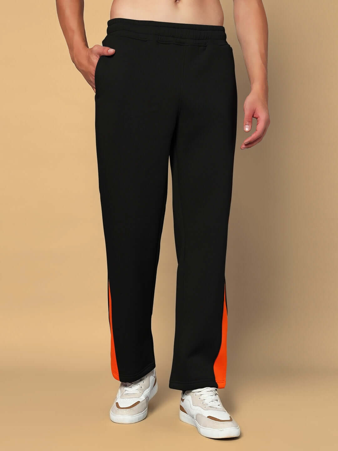 Model wearing WORLDWIDE FLEECE CO-ORD SET BLACK with orange detail, perfect for lounging and casual outings.