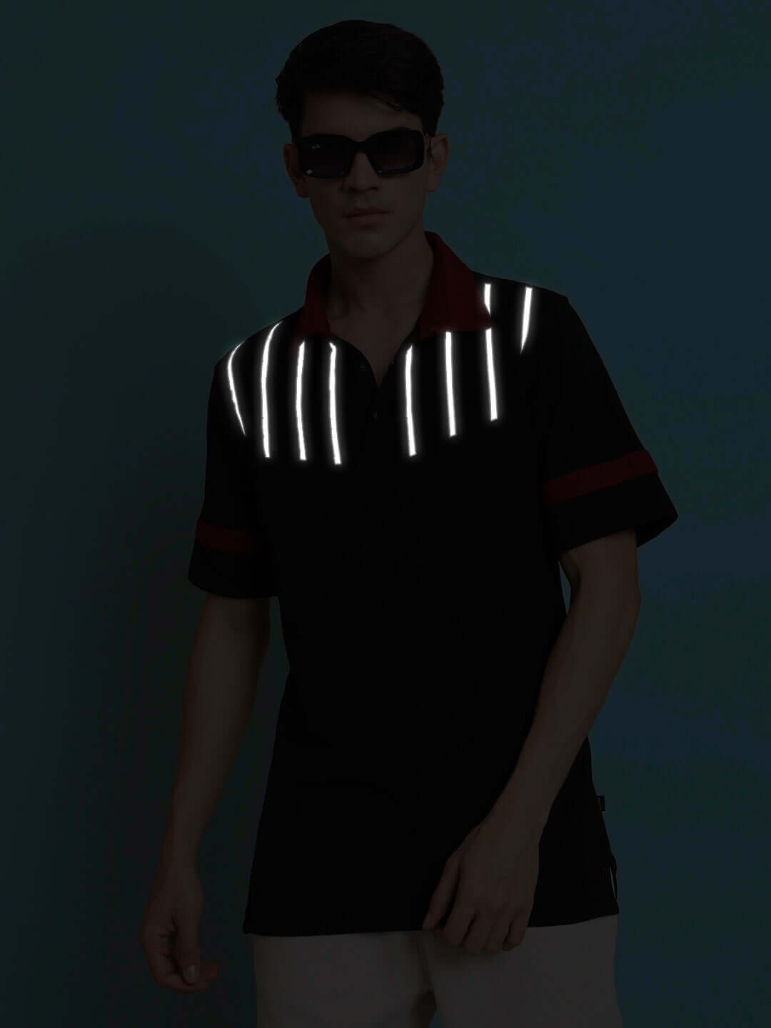 Alt Tag: Black polo neck T-shirt with reflective stripes, worn by male model, showcasing sporty pique fabric with superior stretch in low light.