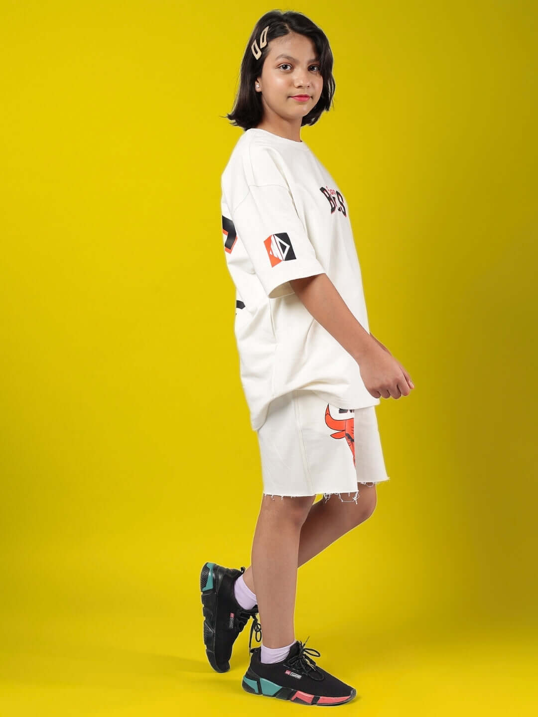 Child wearing BLAZE BULLS CO-ORD FOR BOYS & GIRLS OFF WHITE against yellow background