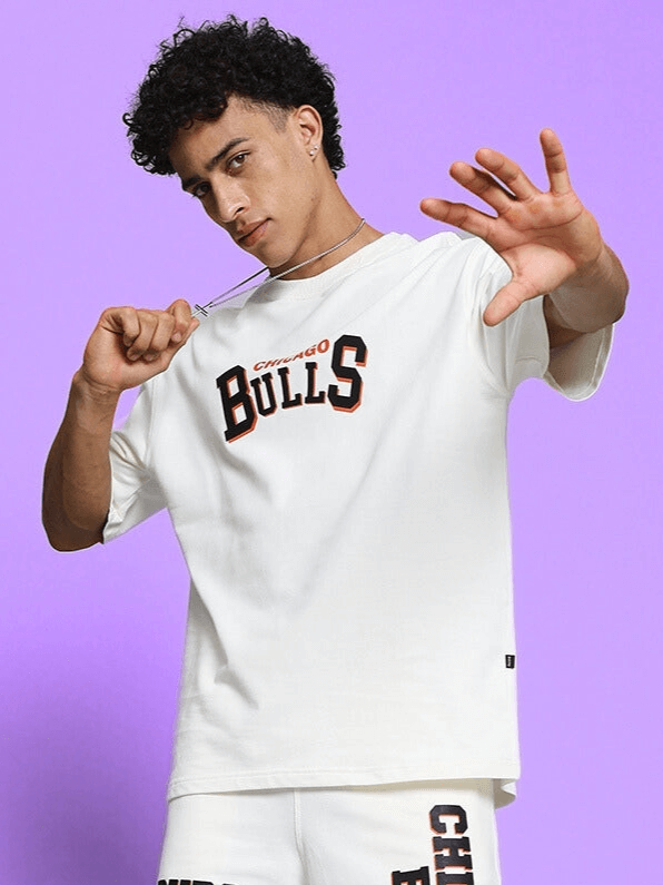 Model wearing BLAZE BULLS PRINT OVER-SIZED T-SHIRT OFF WHITE with bold streetwear style.