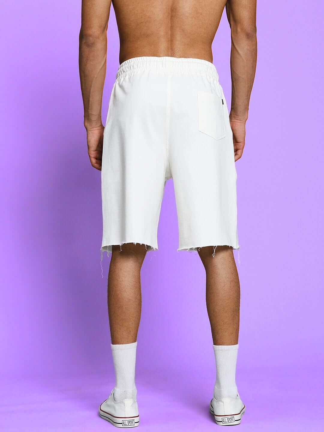 Back view of BLAZE BULLS PRINT REGULAR FIT SHORTS OFF WHITE for kids against purple background.