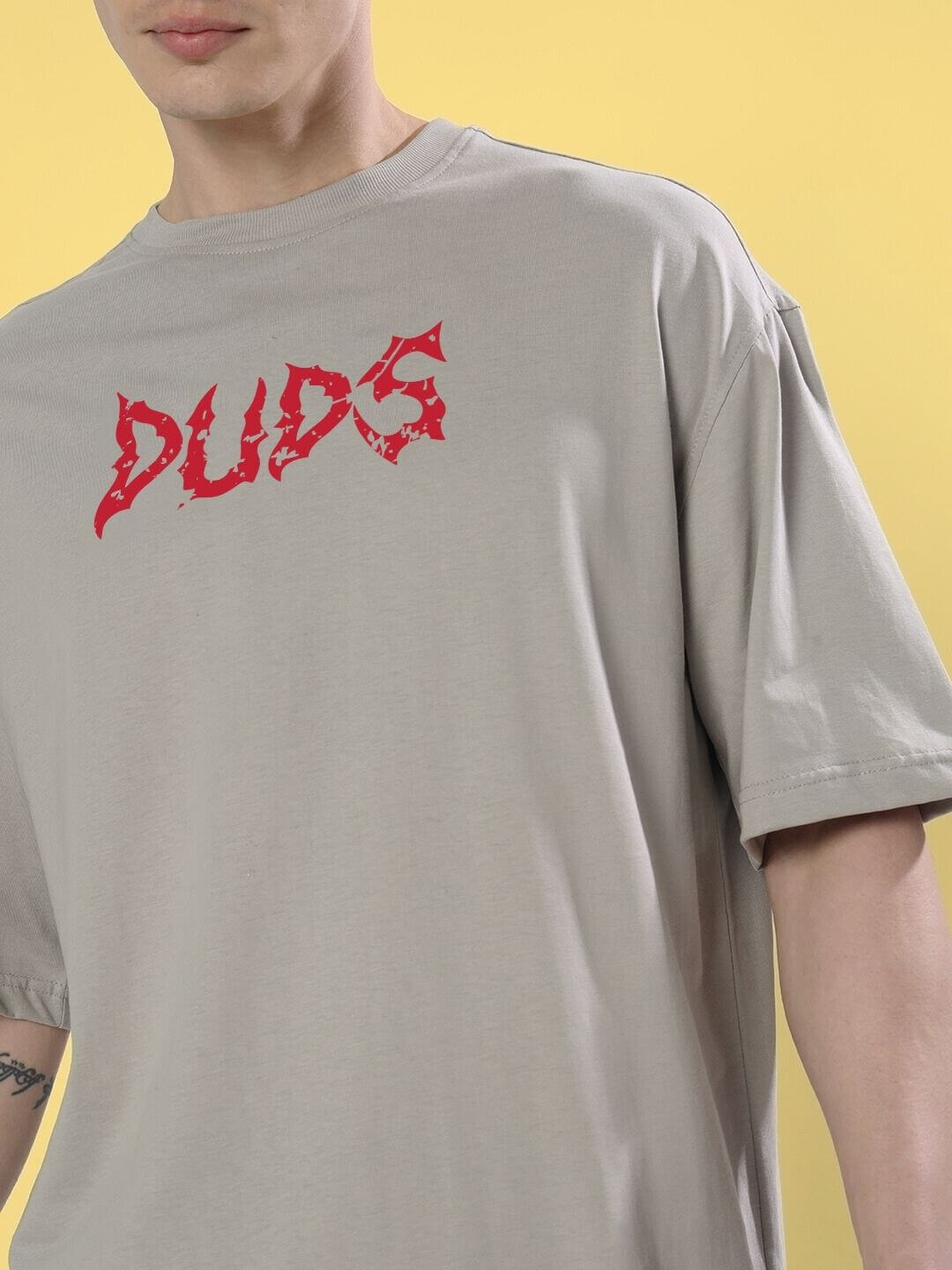 Person wearing BLOODY EYE OVER-SIZED T-SHIRT GREY with bold graphic design.