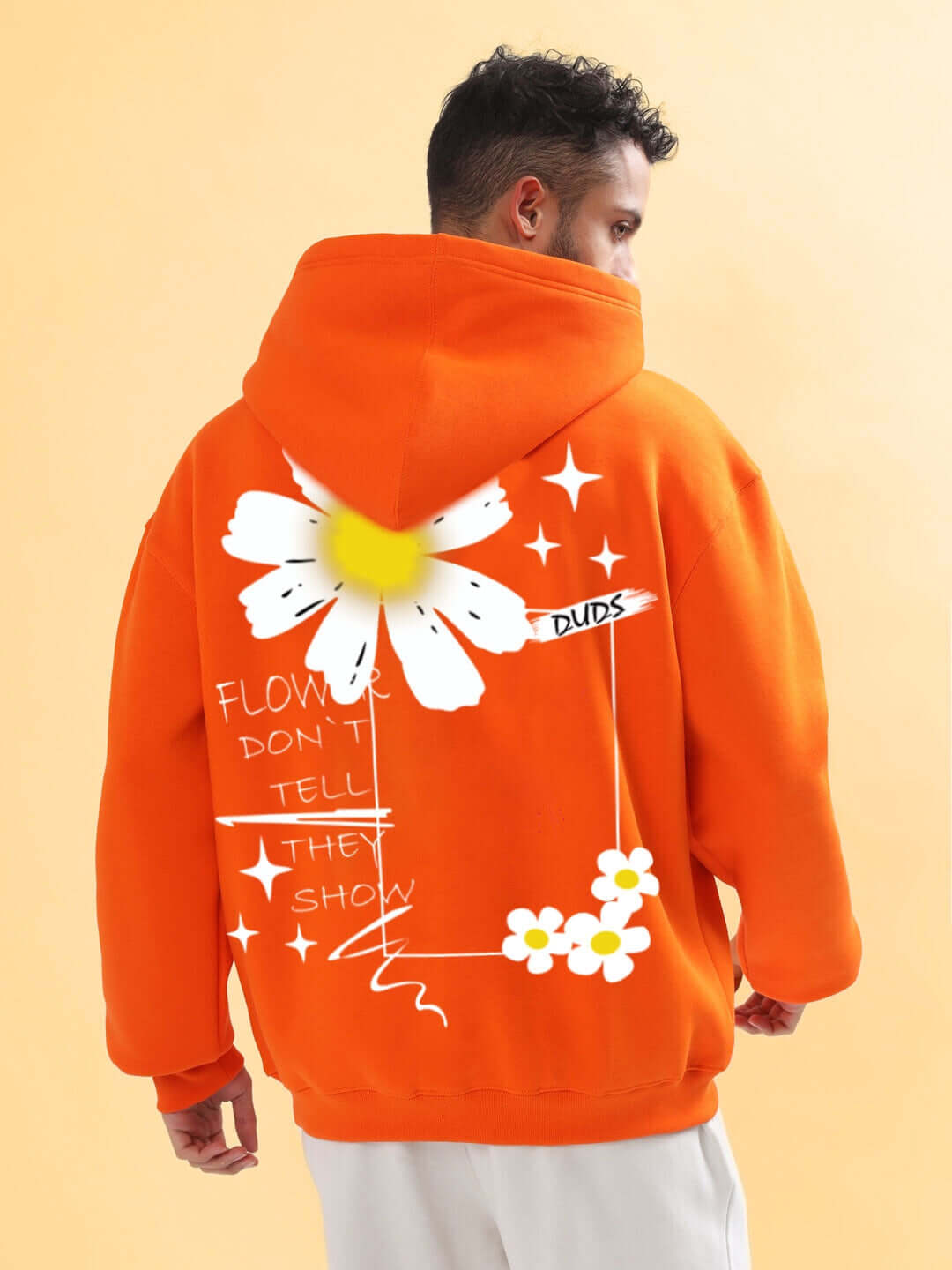 Back view of Bloom Quote Fleece Oversized Hoodie Orange with floral graphic design, worn by a model. Product focus keyword included.