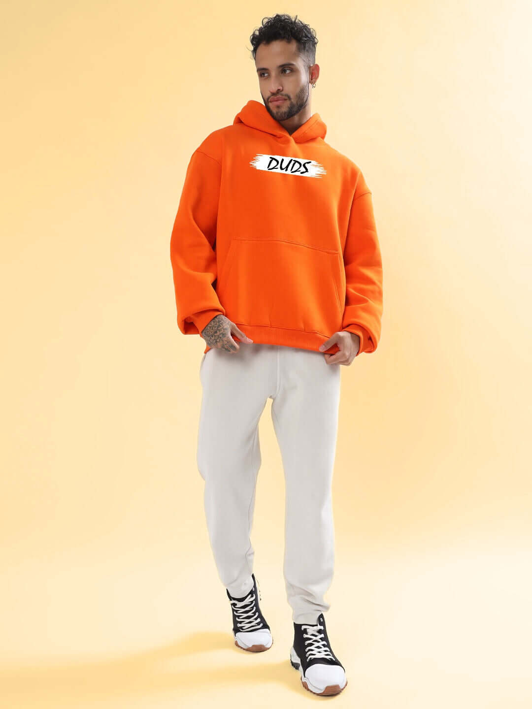 Model wearing BLOOM QUOTE FLEECE OVERSIZED HOODIE ORANGE, showcasing bold streetwear style with premium fleece for comfort and relaxation.