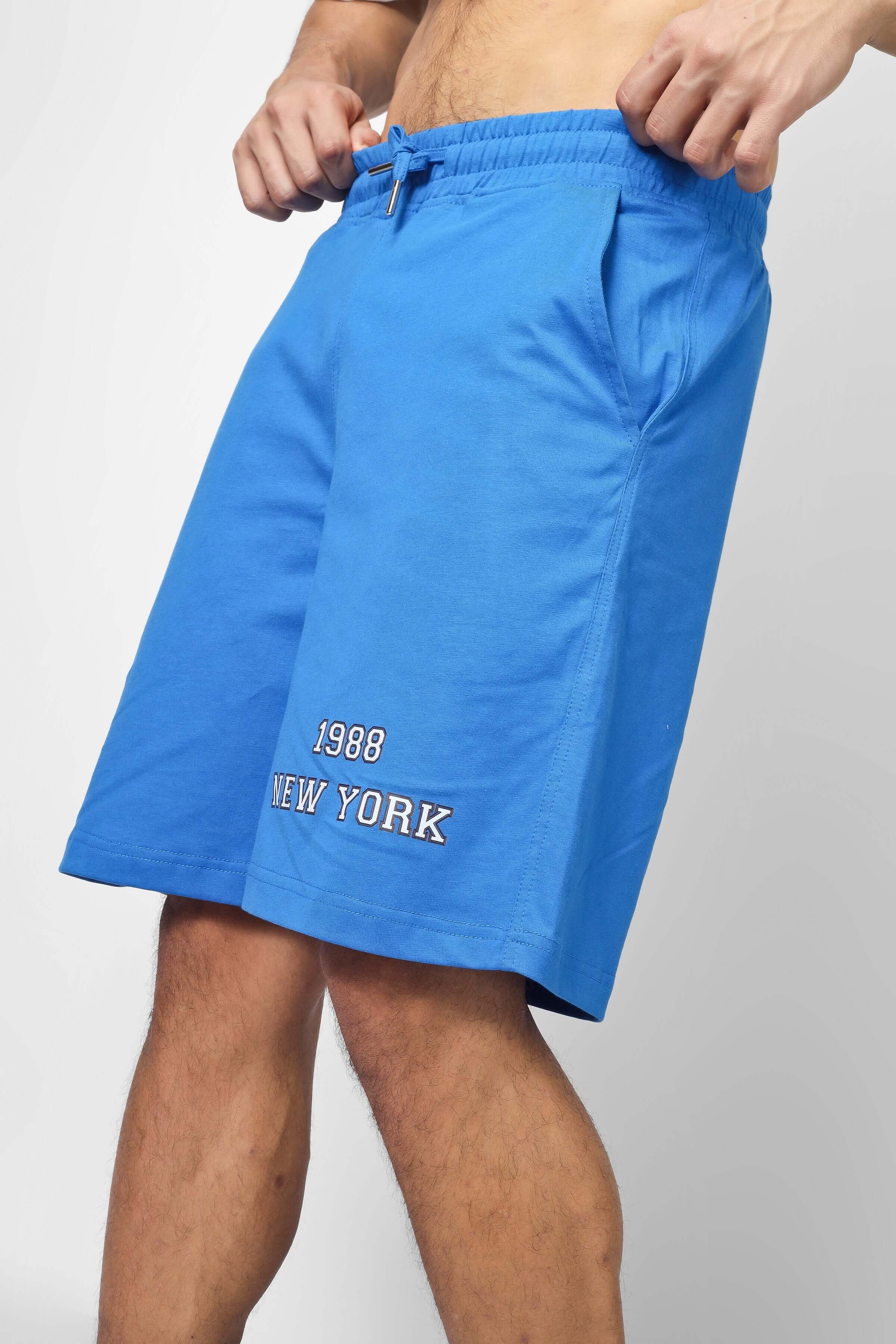 Blue men's shorts with '1988 New York' embroidery, featuring an adjustable drawstring waistband and casual fit.