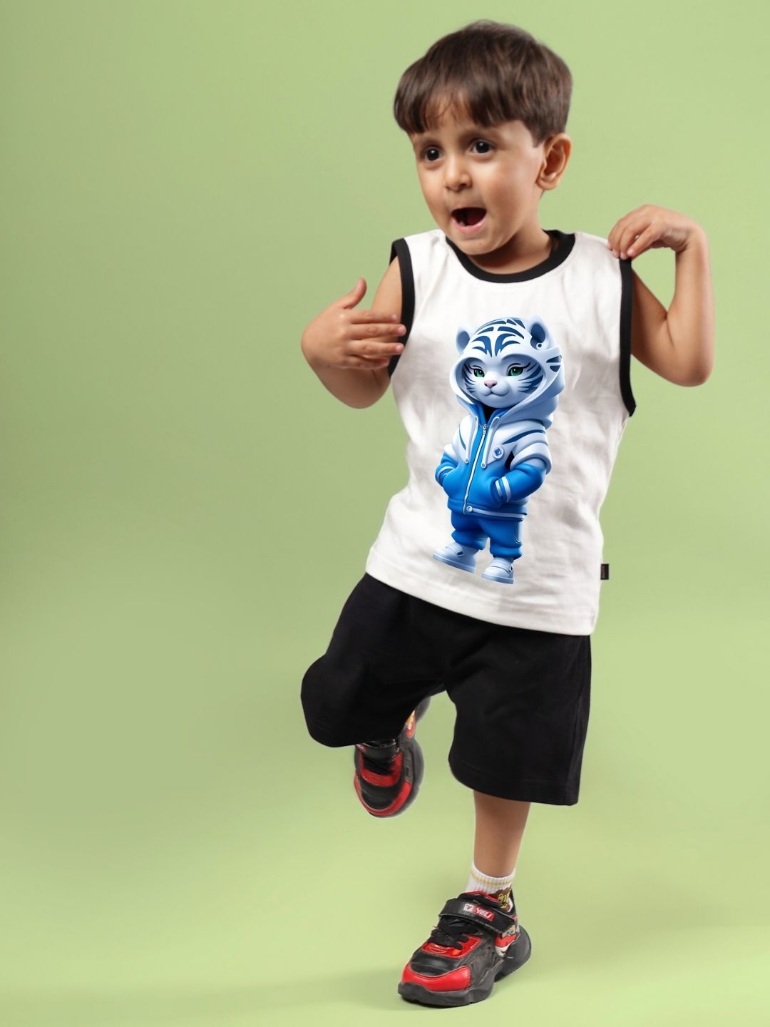 Boy wearing off-white and black Blue Cat summer co-ord set with playful cat design, ideal unisex outfit for children in summer.
