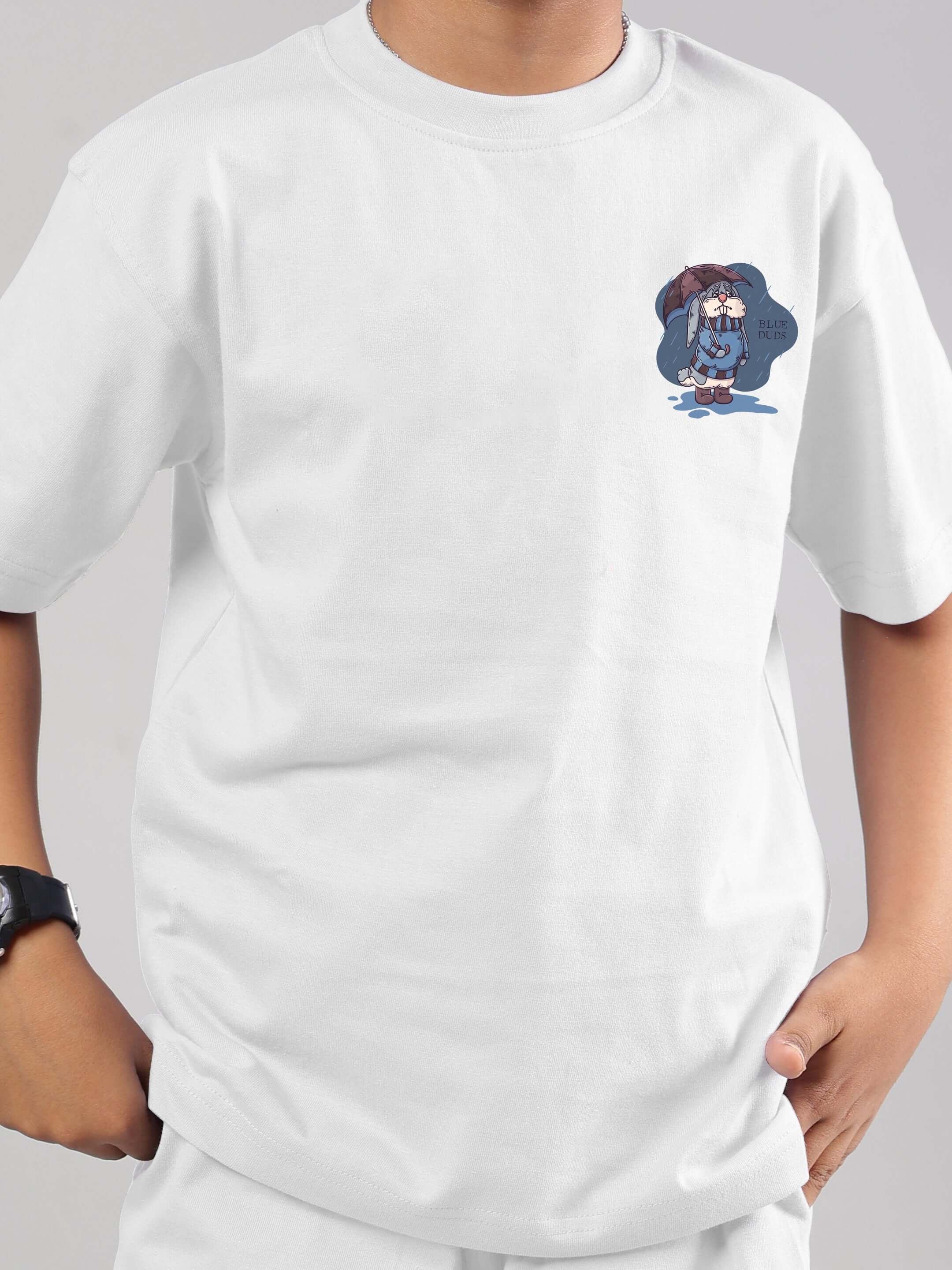 Boy wearing a white Blue Lapin T-shirt by DUDS, featuring a printed design, suitable for boys and girls. Made to order, customizable size.