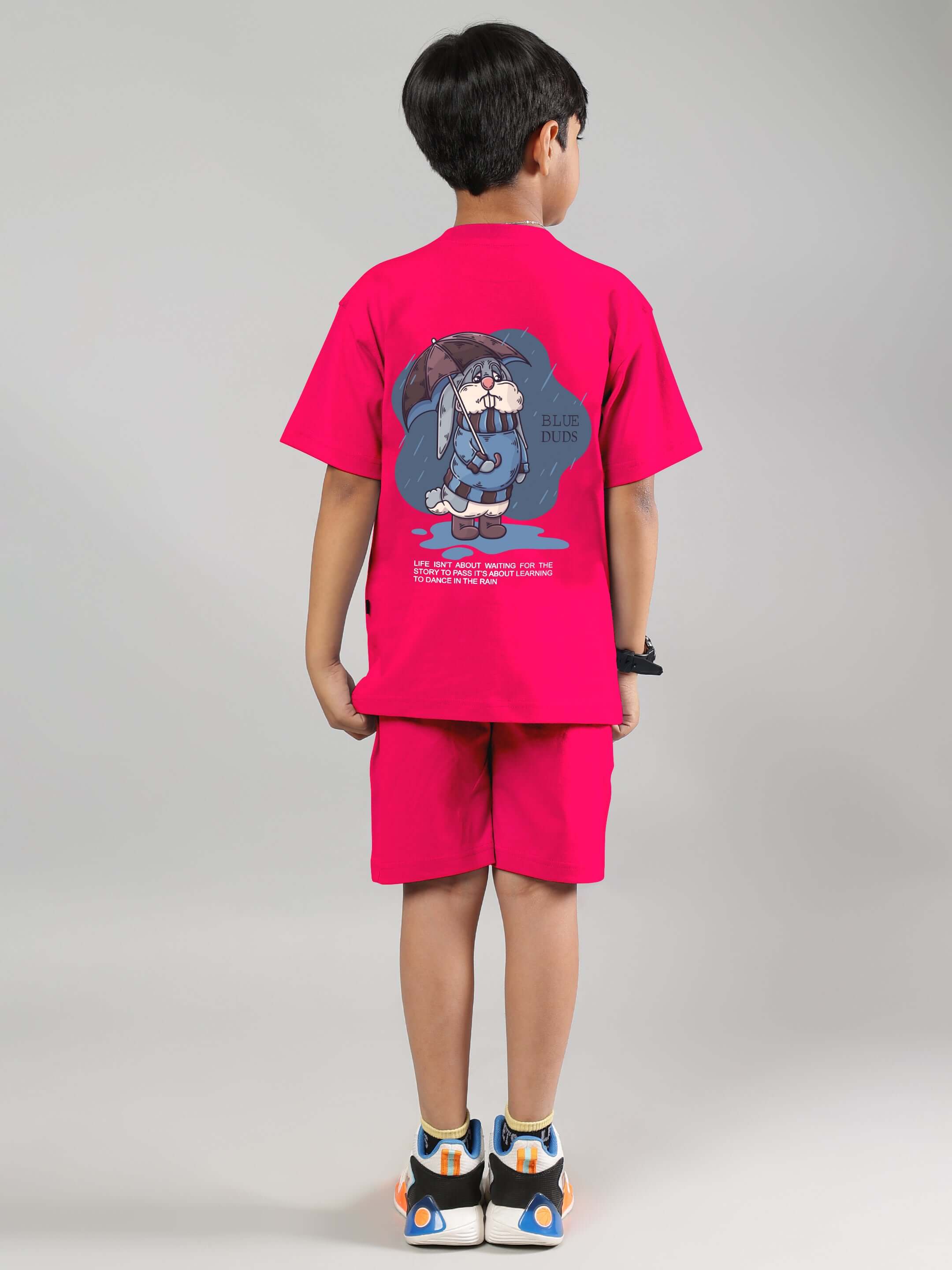 Child wearing BLUE LAPIN CO-ORD FOR BOYS GIRLS PINK set with cute graphic on back, showcasing fashionable and comfortable summer outfit.