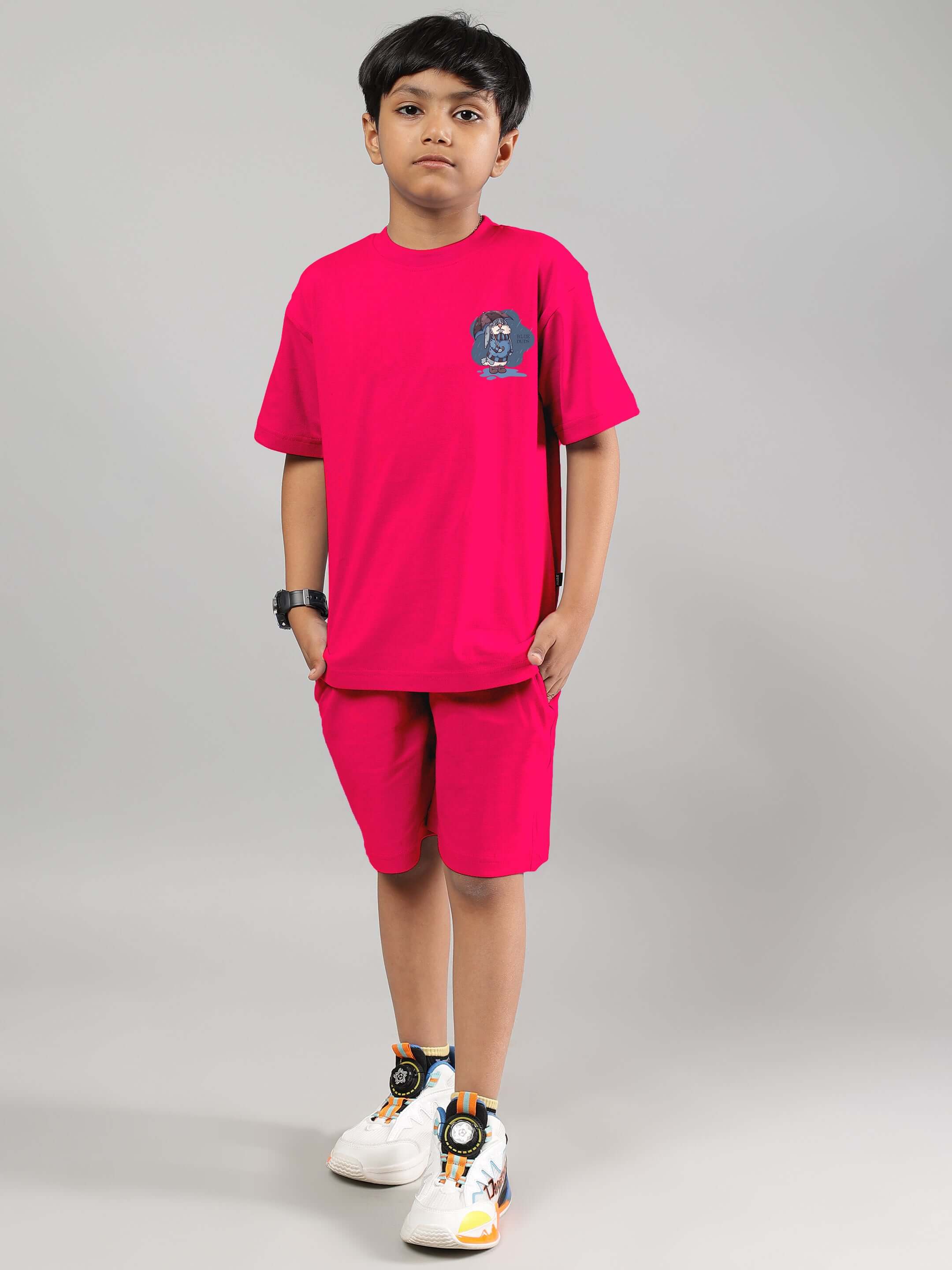 Child wearing BLUE LAPIN CO-ORD FOR BOYS GIRLS PINK cotton set, standing against grey background.