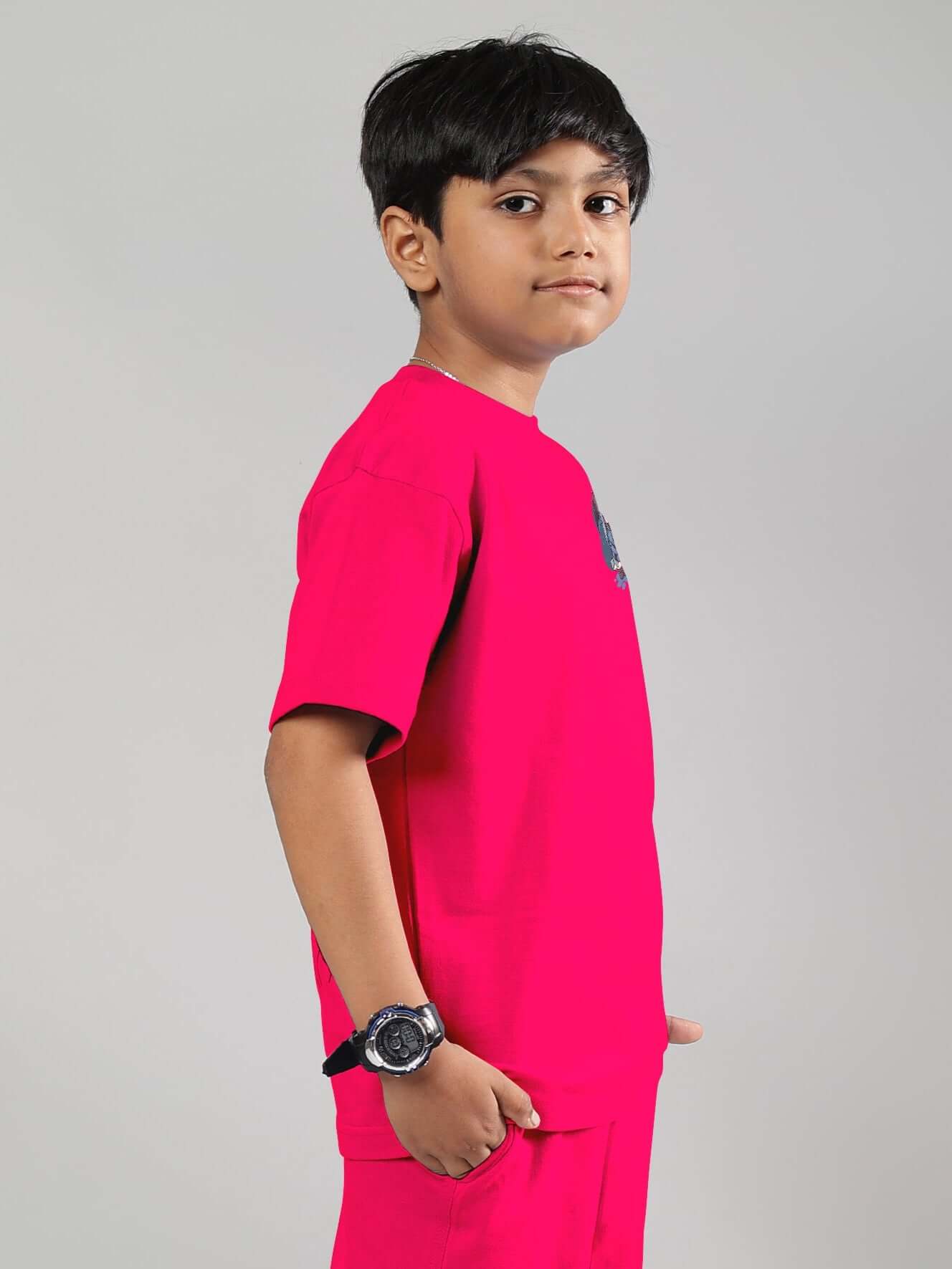 Boy wearing a pink BLUE LAPIN T-shirt with a bunny graphic, showcasing the side view and casual style.