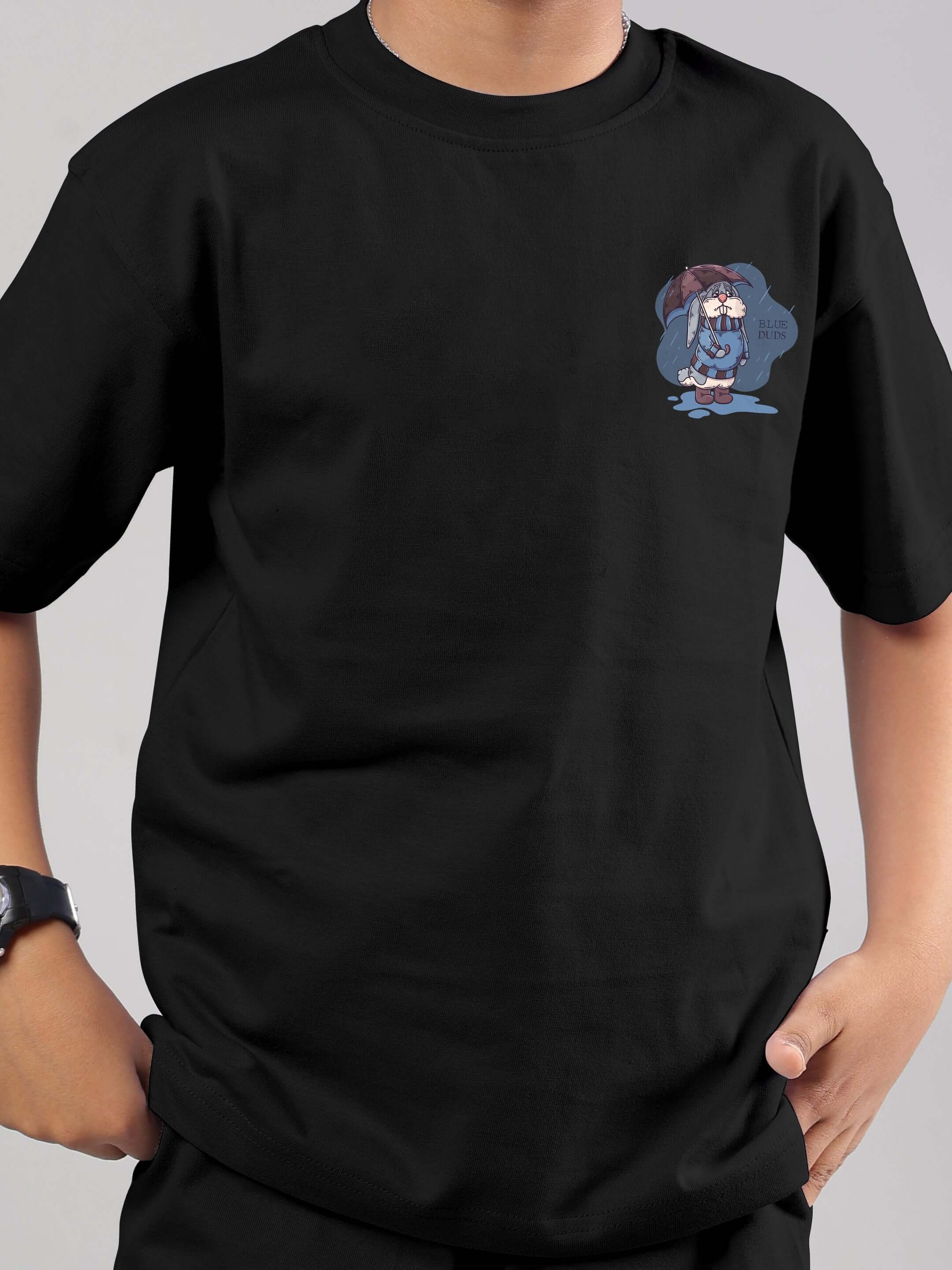 Child wearing a black Blue Lapin T-shirt with a cute bunny print, ideal for playful kids' fashion, made from 100% cotton.