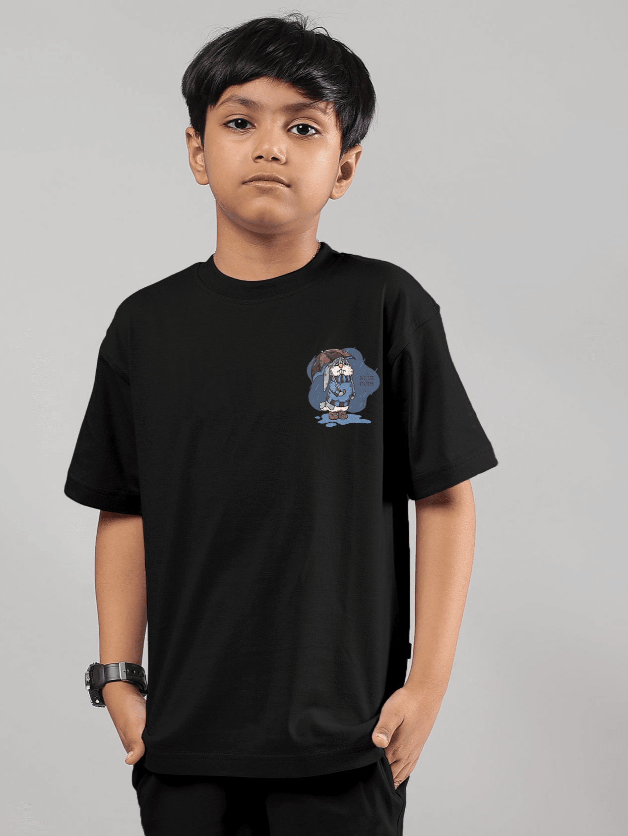 Young boy wearing BLUE LAPIN T-SHIRT FOR BOYS GIRLS BLACK with graphic print, showcasing its soft and stylish cotton-blend design.