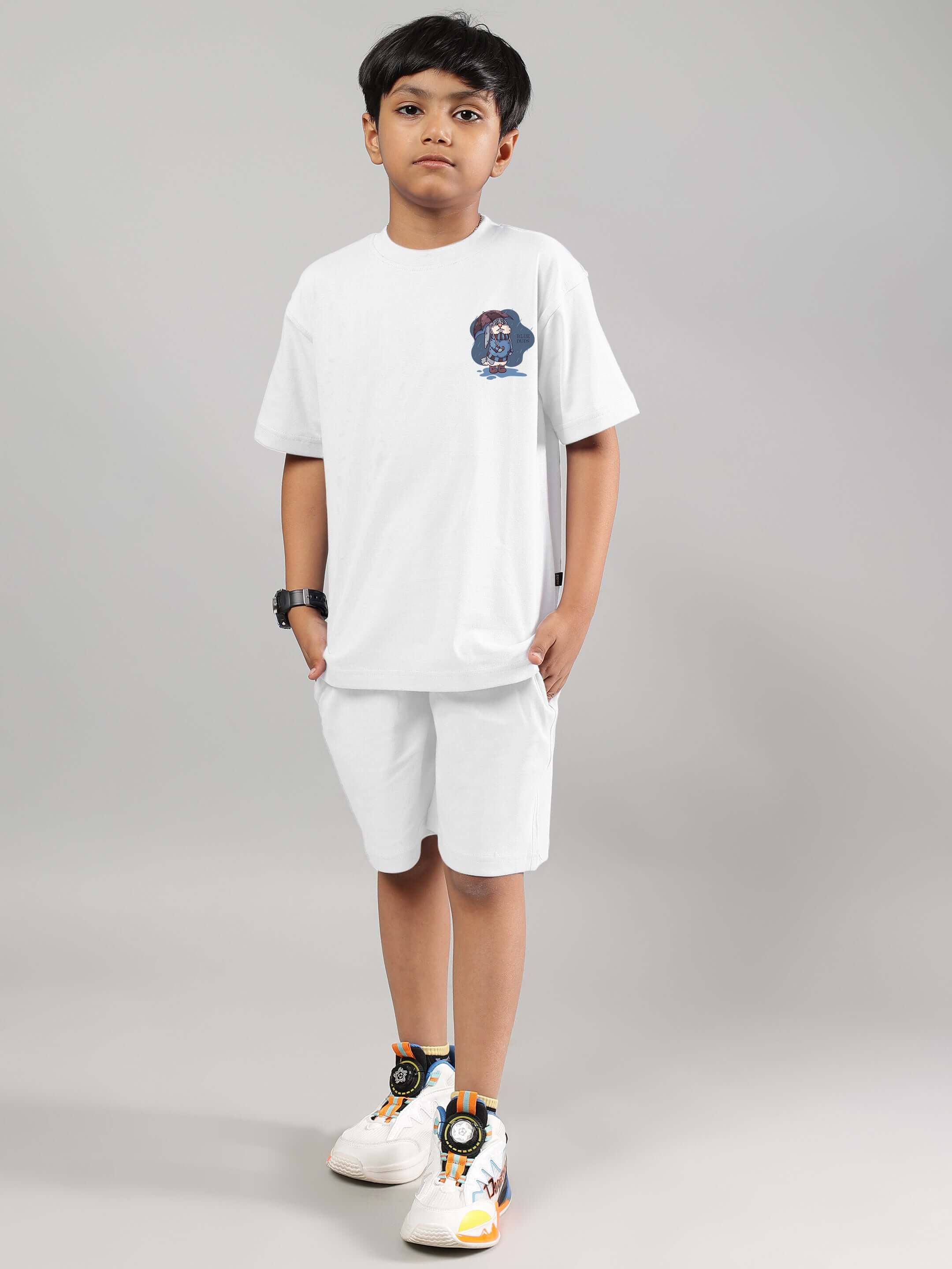 Child wearing a white Blue Lapin t-shirt and shorts, suitable for boys and girls, made by DUDS.