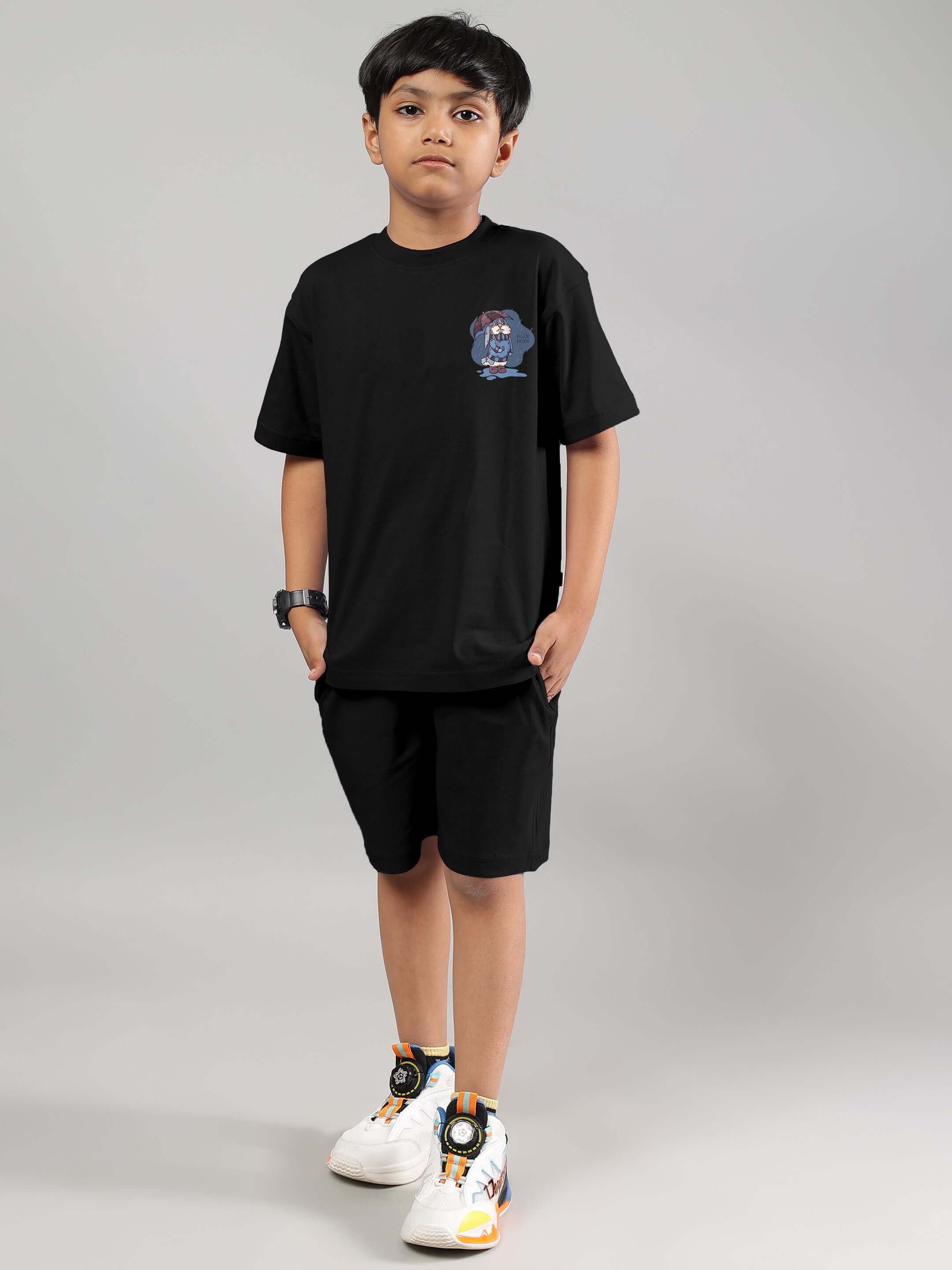 Boy wearing a black Blue Lapin T-shirt for kids, featuring playful bunny print, ideal for stylish and comfortable everyday wear.