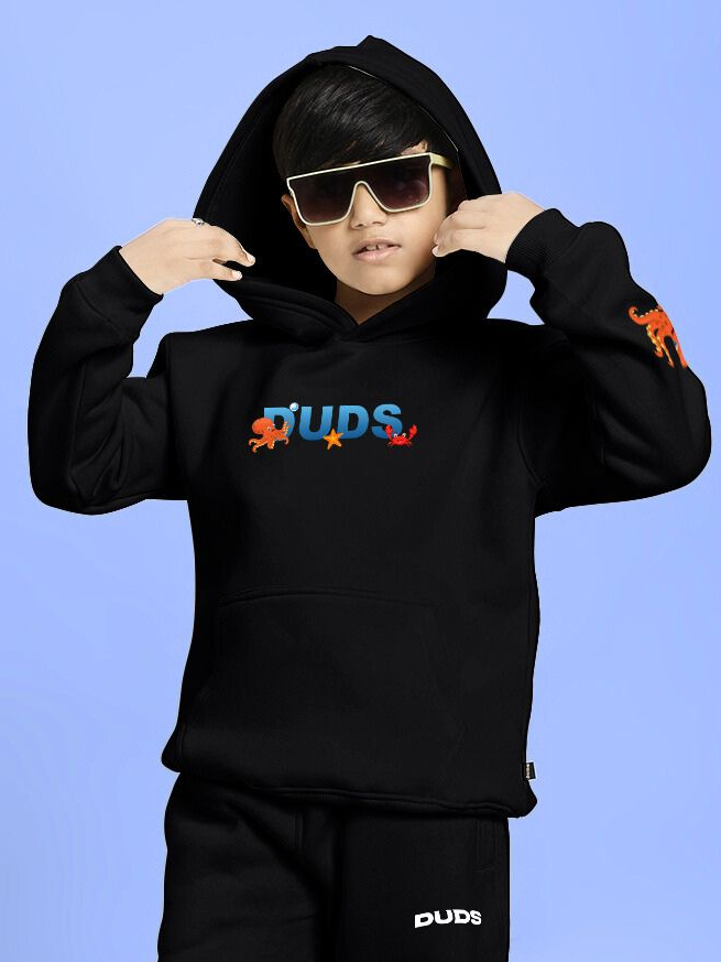 Child wearing a BLUE OCEAN WORLD FLEECE HOODIE FOR BOYS AND GIRLS BLACK with cool sunglasses, showcasing a modern street style look.