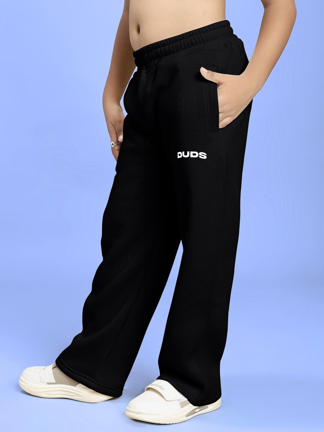 Child wearing BLUE OCEAN WORLD FLEECE JOGGER FOR BOYS AND GIRLS BLACK, showcasing trendy cozy streetwear style.