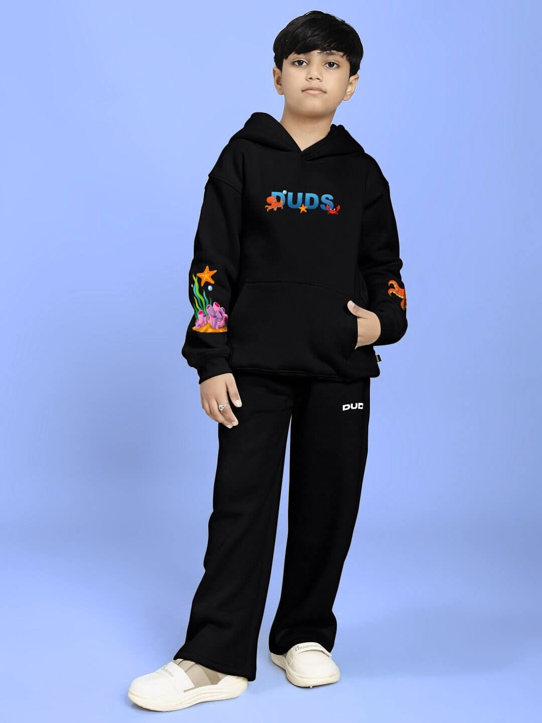 Child wearing BLUE OCEAN WORLD FLEECE CO-ORD FOR BOYS AND GIRLS BLACK, showcasing the stylish black sweatshirt and joggers set.