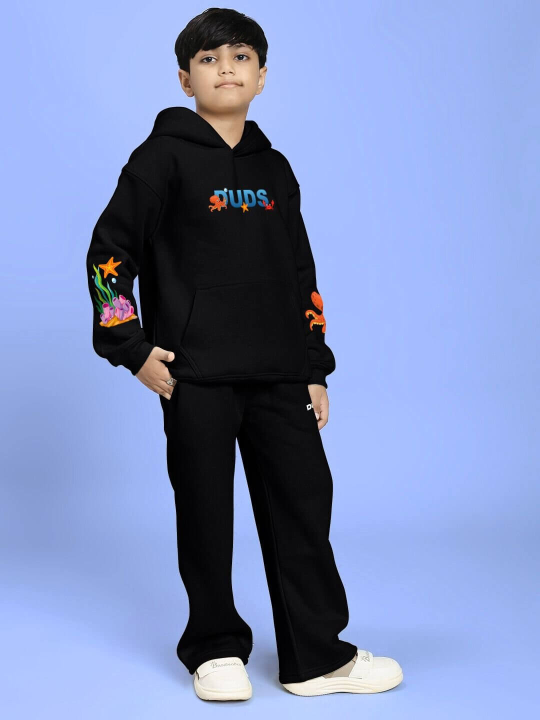 Child wearing BLUE OCEAN WORLD FLEECE CO-ORD FOR BOYS AND GIRLS BLACK, featuring a relaxed-fit sweatshirt and joggers set.