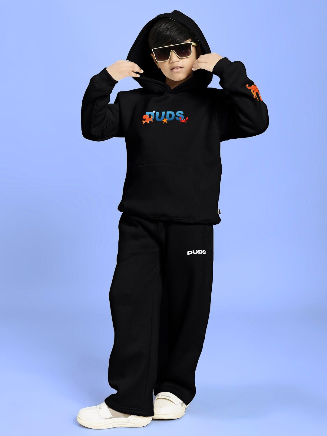 Child wearing BLUE OCEAN WORLD FLEECE CO-ORD FOR BOYS AND GIRLS BLACK, featuring a black sweatshirt and joggers set.