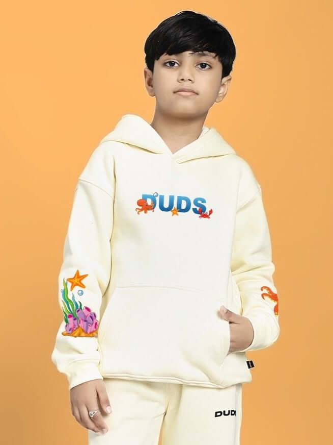 BLUE OCEAN WORLD FLEECE HOODIE FOR BOYS AND GIRLS OFF-WHITE worn by child on orange background