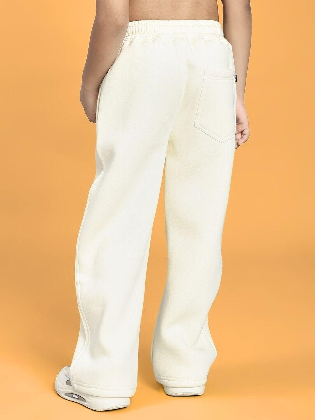 Child wearing BLUE OCEAN WORLD FLEECE JOGGER FOR BOYS AND GIRLS OFF-WHITE, rear view, showcasing style and fit.