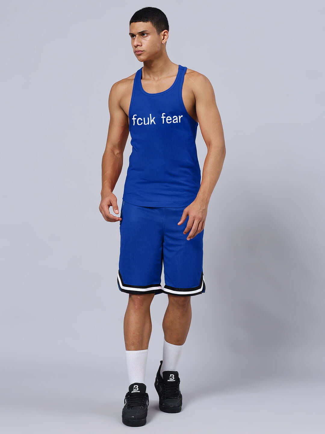 Man wearing FEARLESS PRINTED GYM CO-ORD SET BLUE with bold top and matching shorts, embodying power and confidence in workout attire.