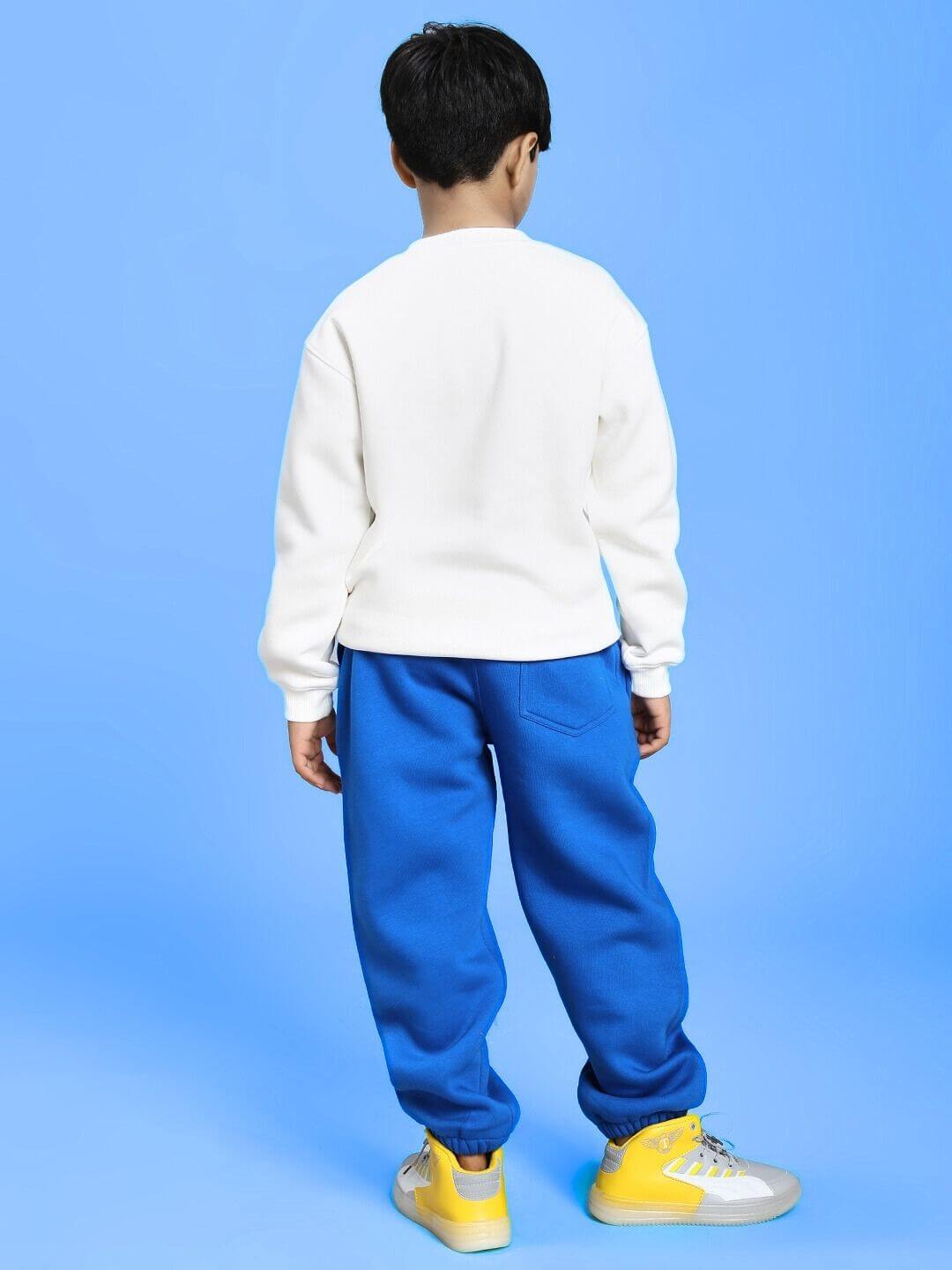 Child wearing BLUEY BINGO FLEECE CO-ORD FOR BOYS AND GIRLS WHITE BLUE against a blue background, showcasing the back view.