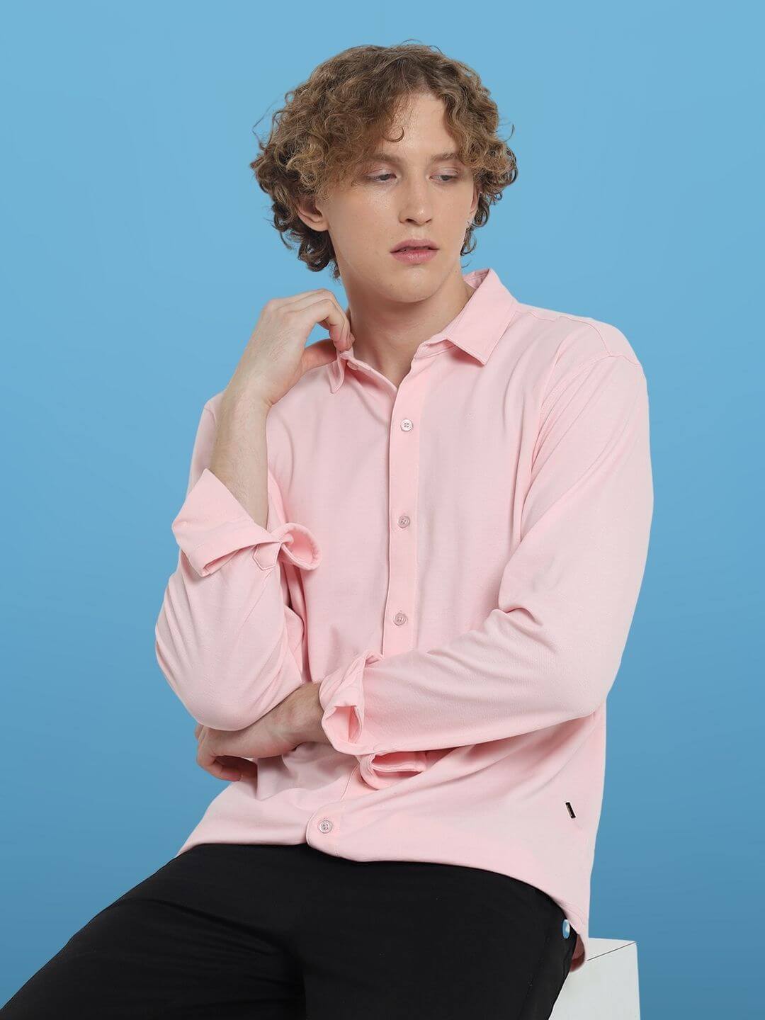 Model wearing blush pink sporty pique shirt with full sleeves and curved hem, showcasing a comfortable, slim fit design in 100% cotton lycra.