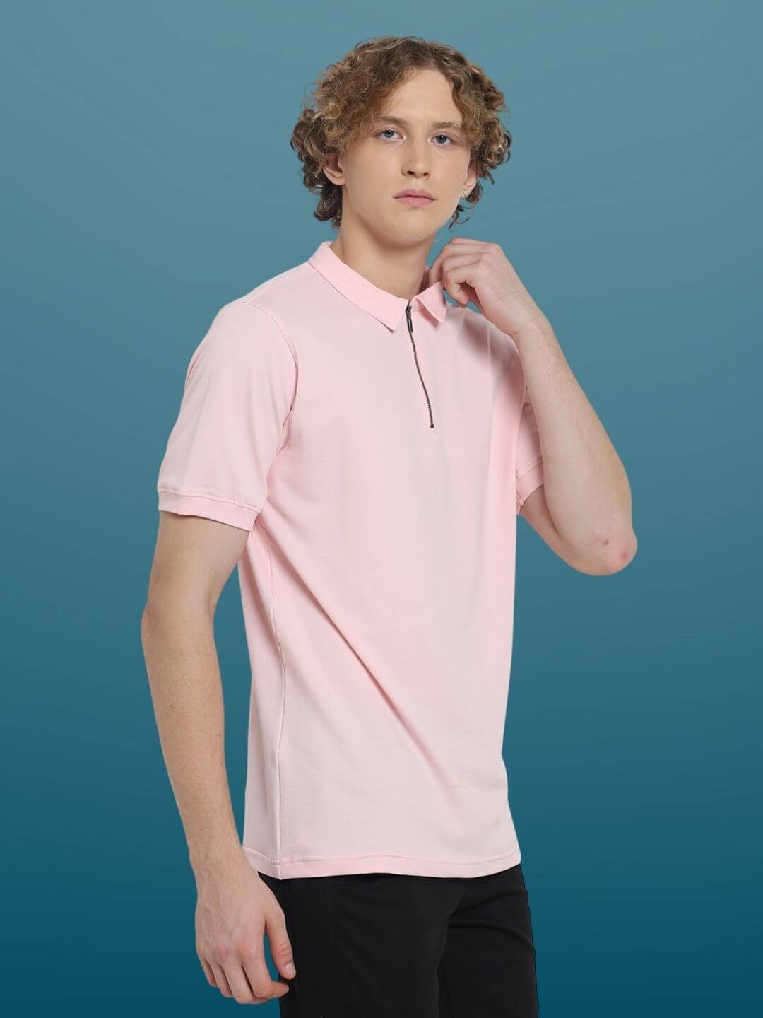 Model wearing blush pink zipper polo neck T-shirt, half sleeves, slim fit. Features 4-way stretch, wrinkle-free fabric. Comfortable for all-day wear.