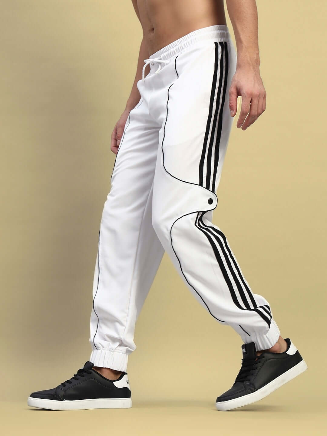 Person wearing Bolson Stripes Relaxed-Fit Joggers in white with black stripes, custom fit option available for unique sizes.