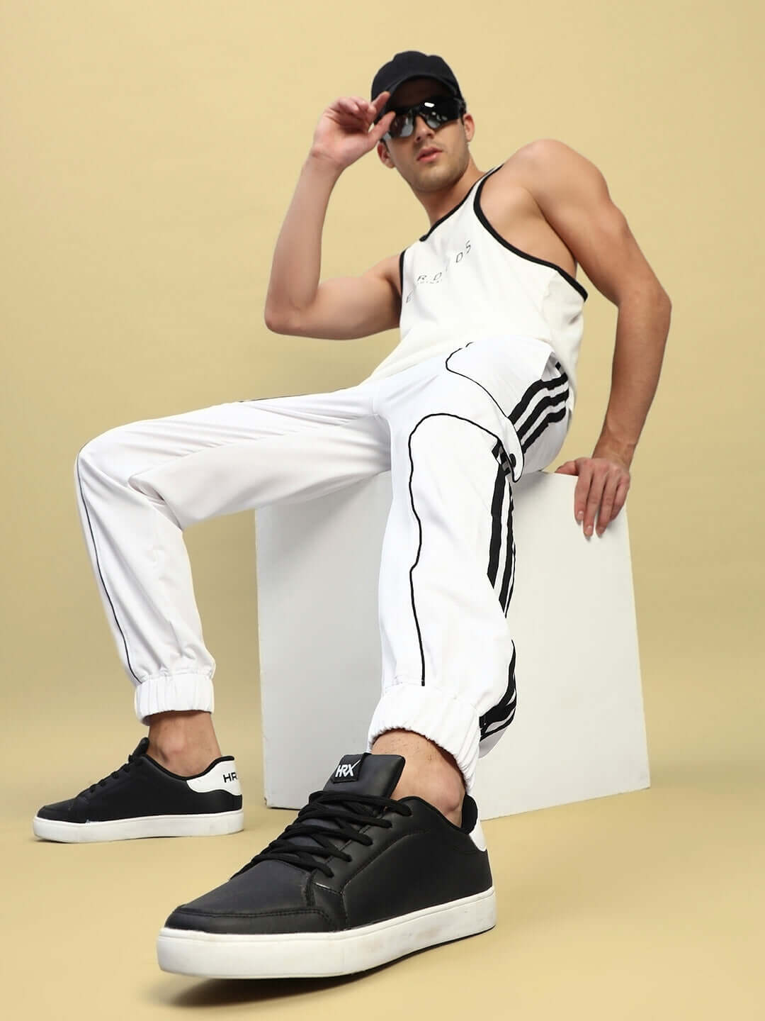 Model wearing Bolson Stripes Relaxed-Fit Joggers in white, showcasing the comfortable fit and stylish design in a casual pose.