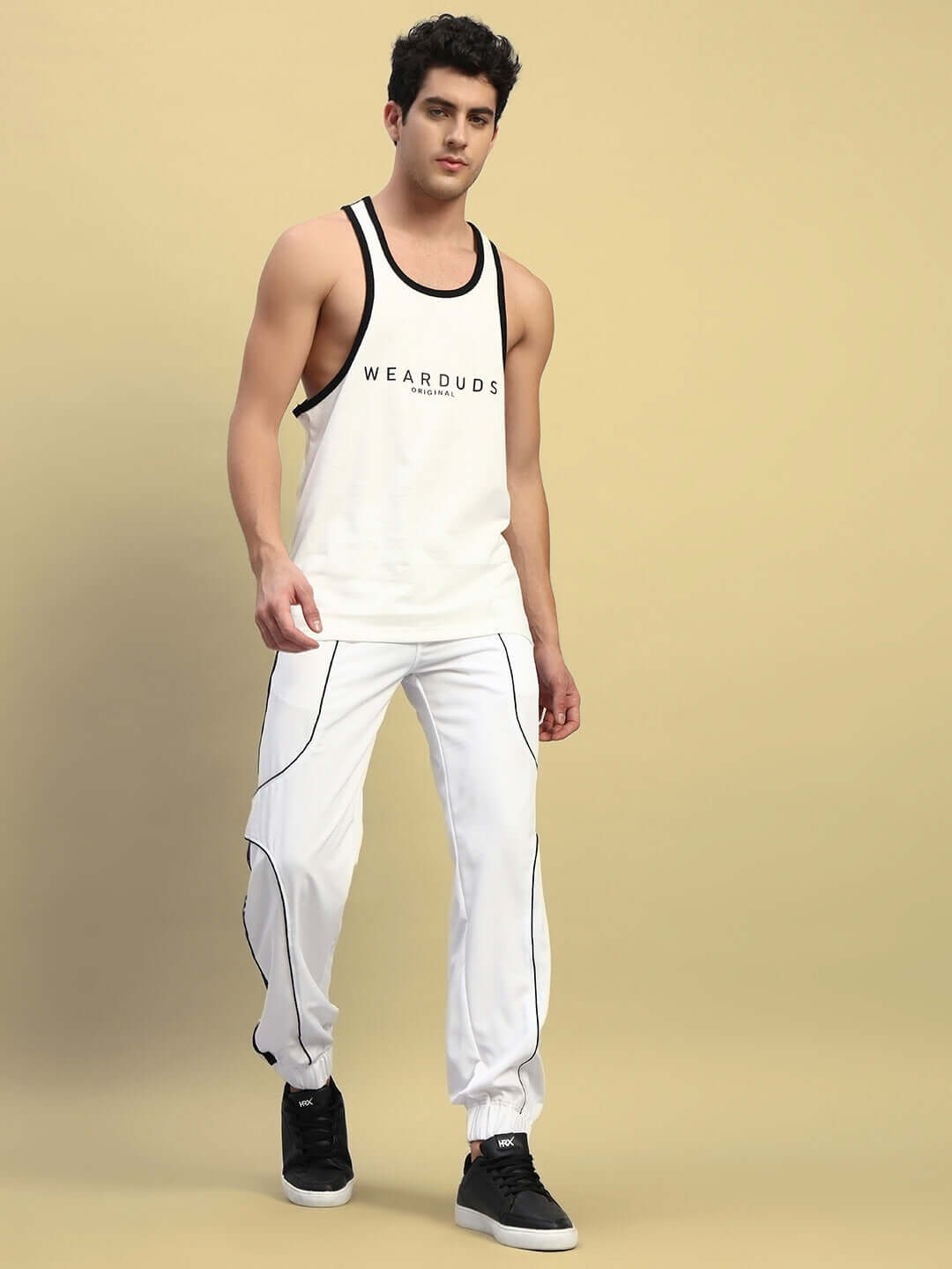Model wearing Bolson Stripes Relaxed-Fit Joggers in white, showcasing custom fit option for comfortable, stylish casual wear.
