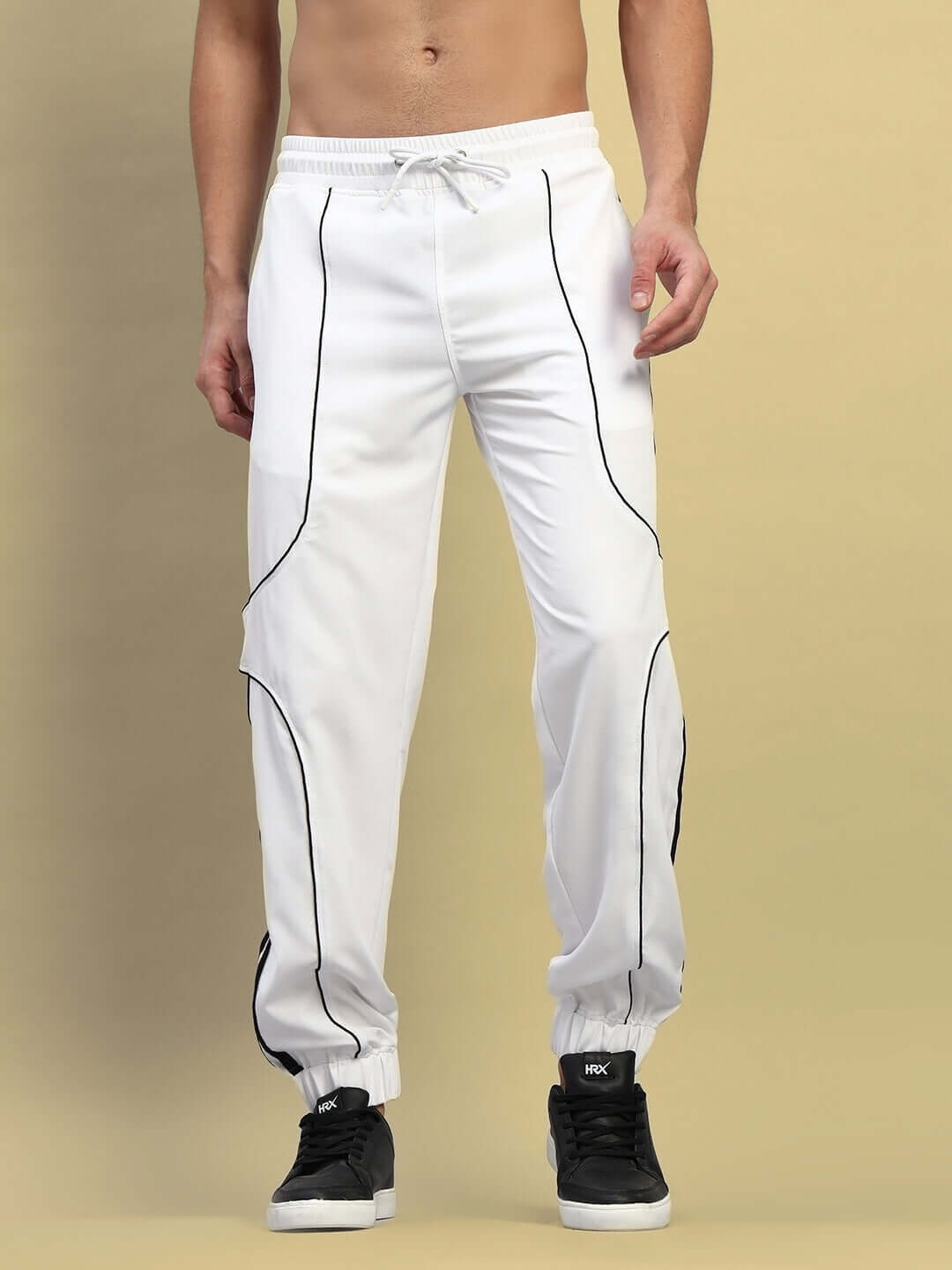 Front view of BOLSON Stripes Relaxed-Fit Joggers in white, showcasing black piping details and adjustable drawstring waist.