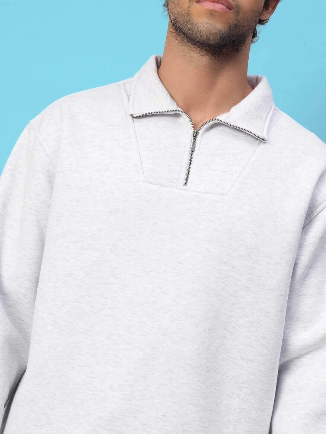Man wearing Bona-Fide melange grey sweatshirt with zip collar, showcasing minimalist streetwear design.
