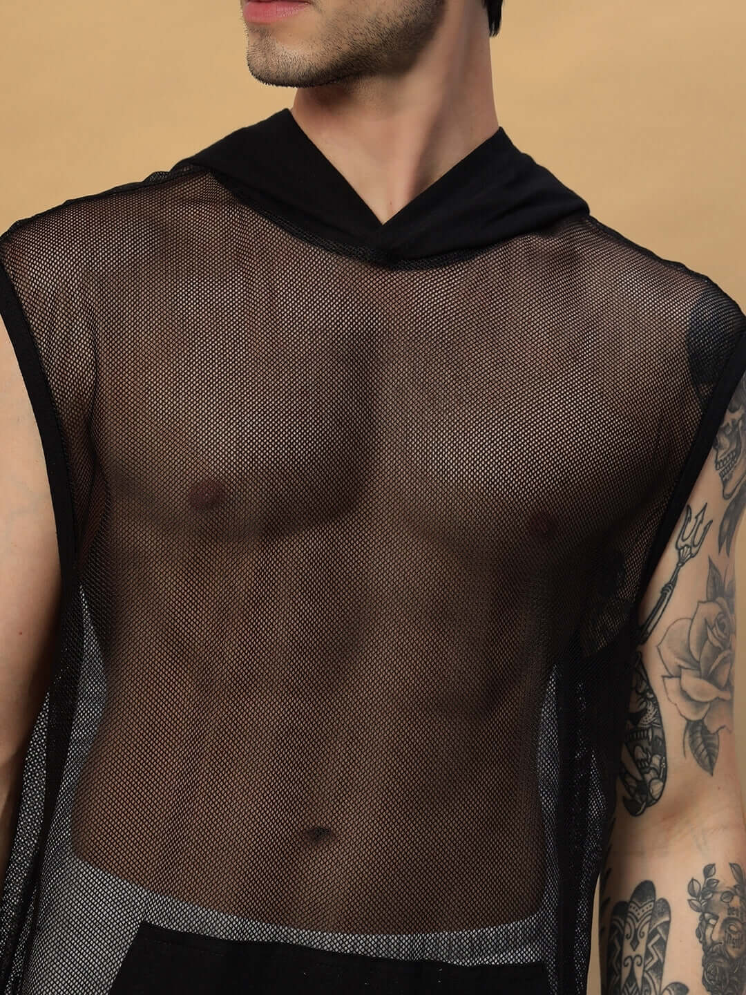 Model wearing a black Boogie mesh sleeveless hoodie vest showcasing tattooed arm and stylish transparent design.