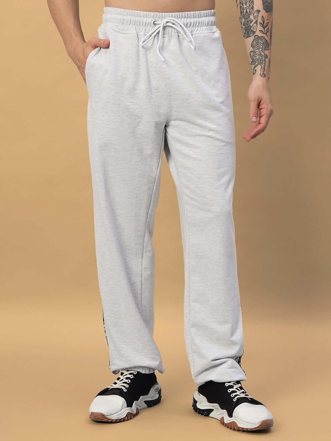Model wearing Boogie Relaxed Fit Joggers in melange grey, showcasing comfortable and stylish design with customizable fit options.
