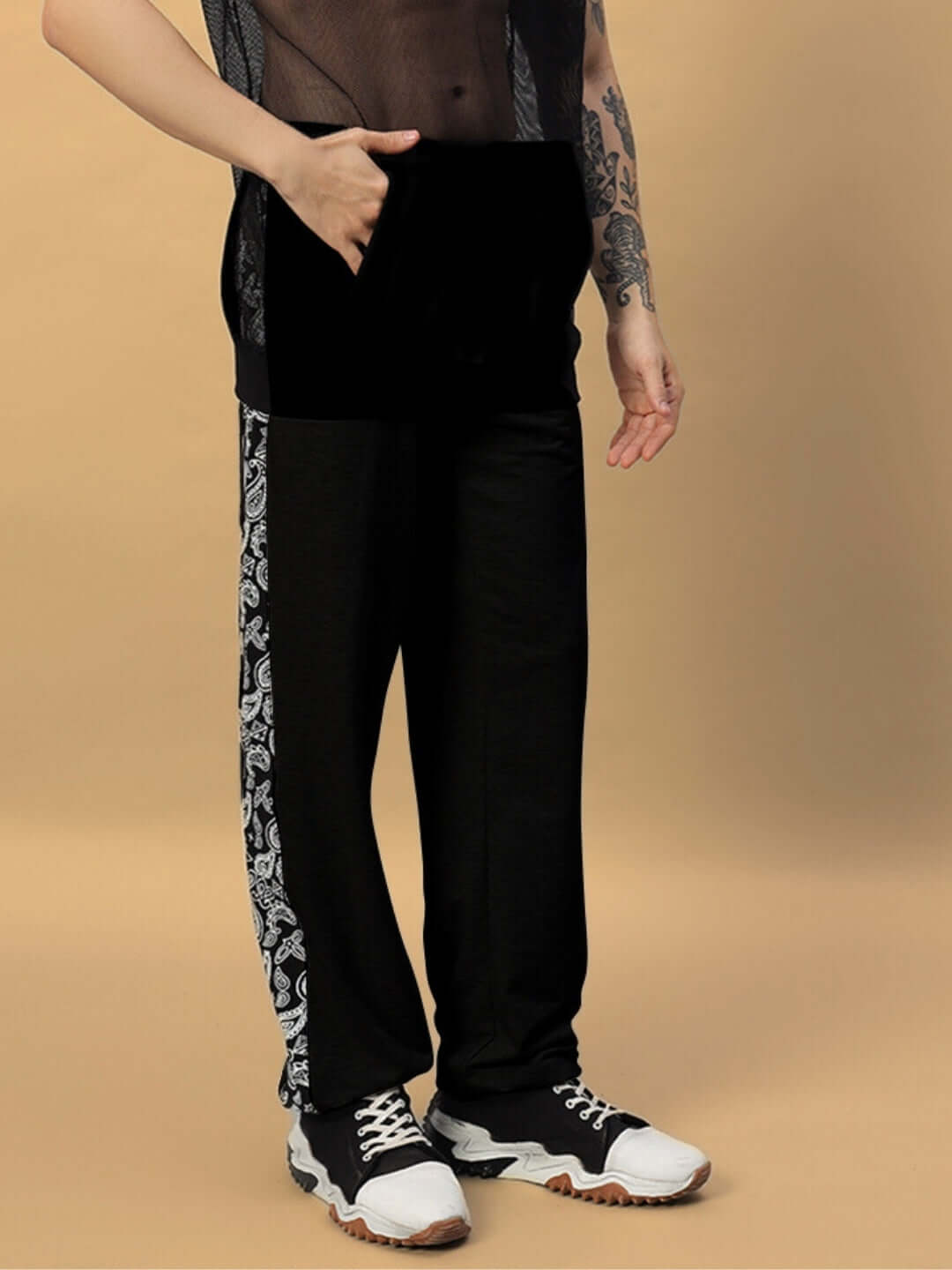 Person wearing Boogie Relaxed Fit Joggers in black with patterned sides, styled with casual sneakers.