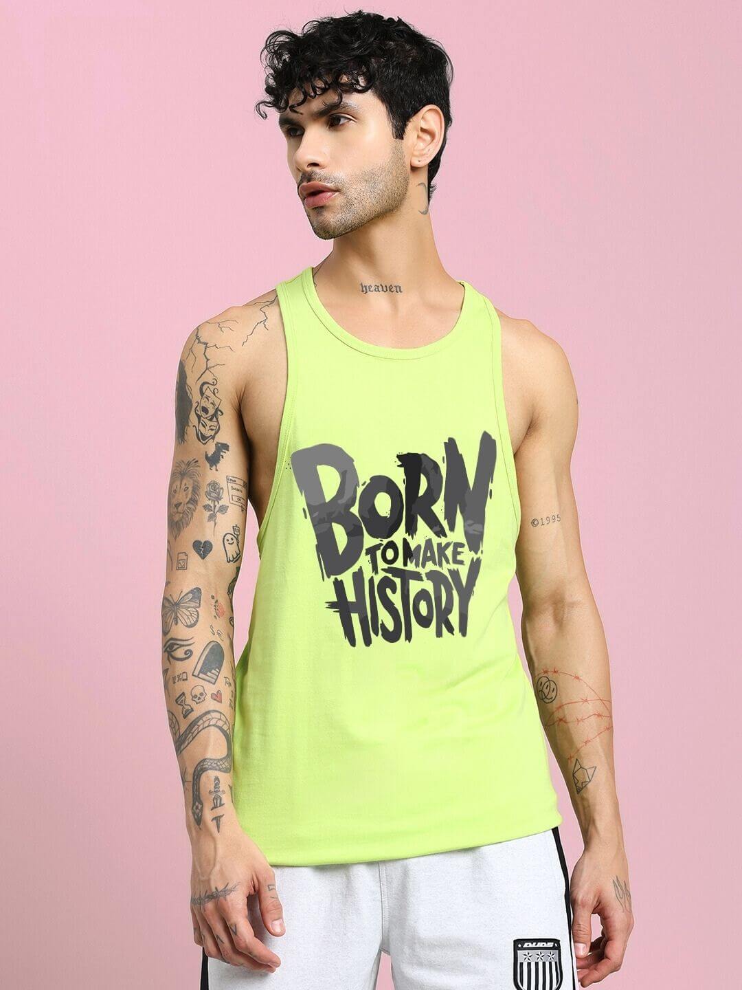 BORN TO MAKE HISTORY GYM VEST T-SHIRT NEON GREEN worn by model against a pink background