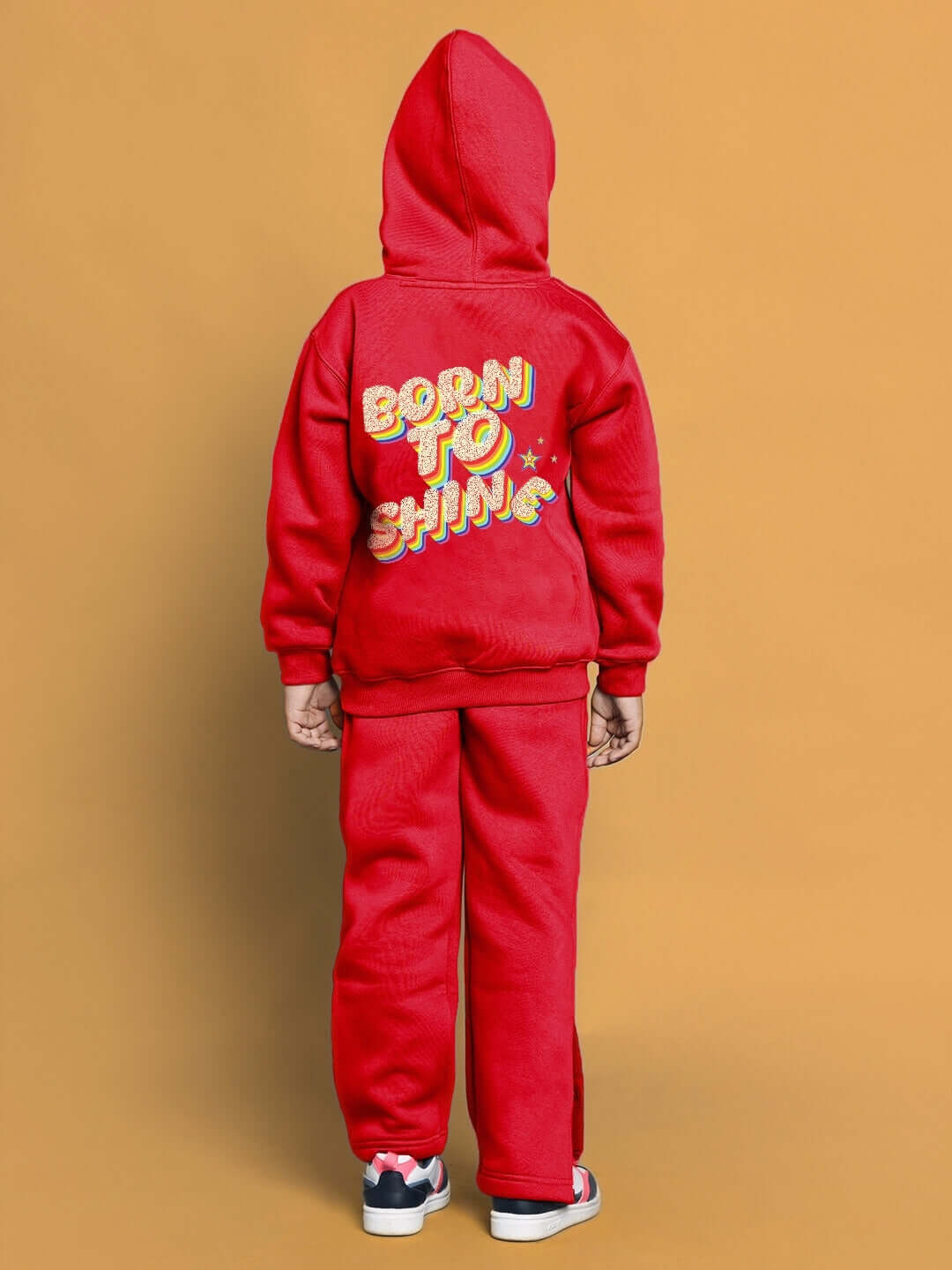 Child wearing red BORN TO SHINE co-ord set, featuring a hoodie and pants, suitable for boys and girls.