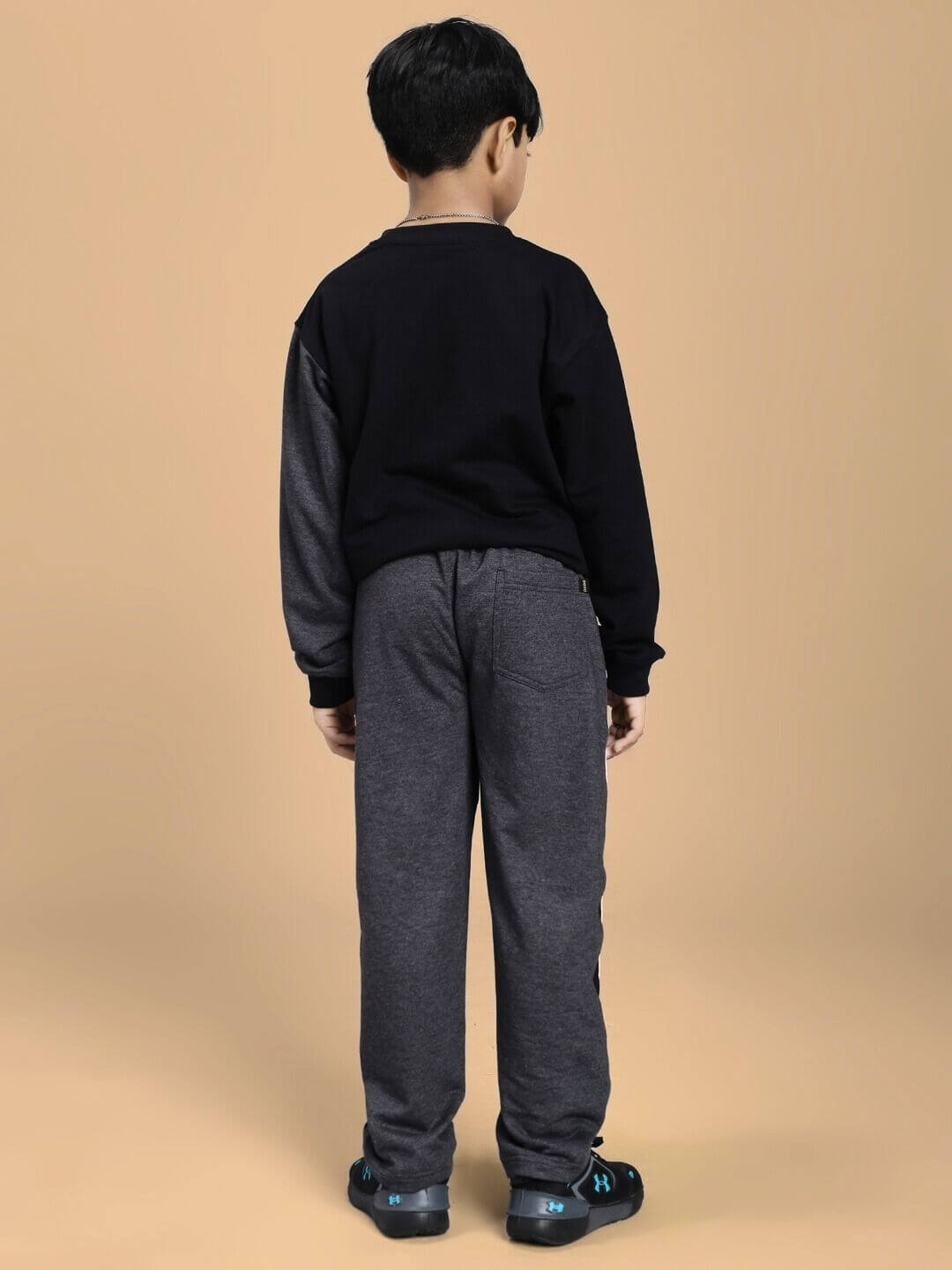 Child wearing BOSCO STRIPE CO-ORD SET FOR BOYS AND GIRLS BLACK DARK GREY from back view, showcasing the comfortable and stylish outfit.