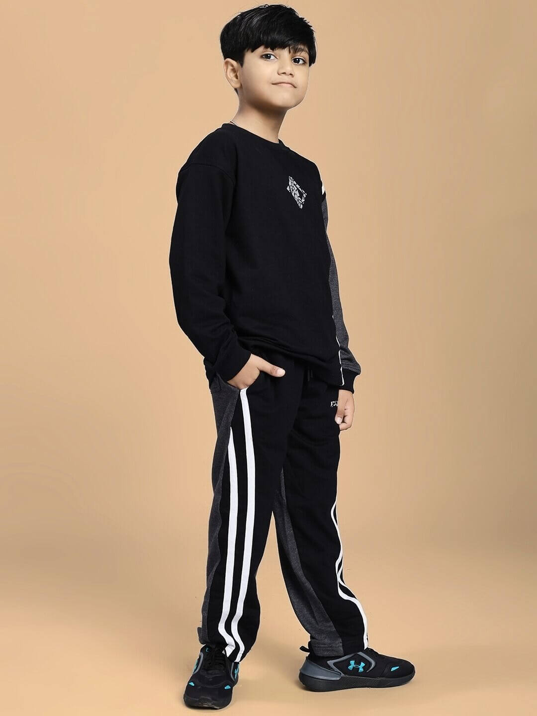 Child wearing BOSCO STRIPE CO-ORD SET FOR BOYS AND GIRLS BLACK DARK GREY sweatshirt and jogger set.