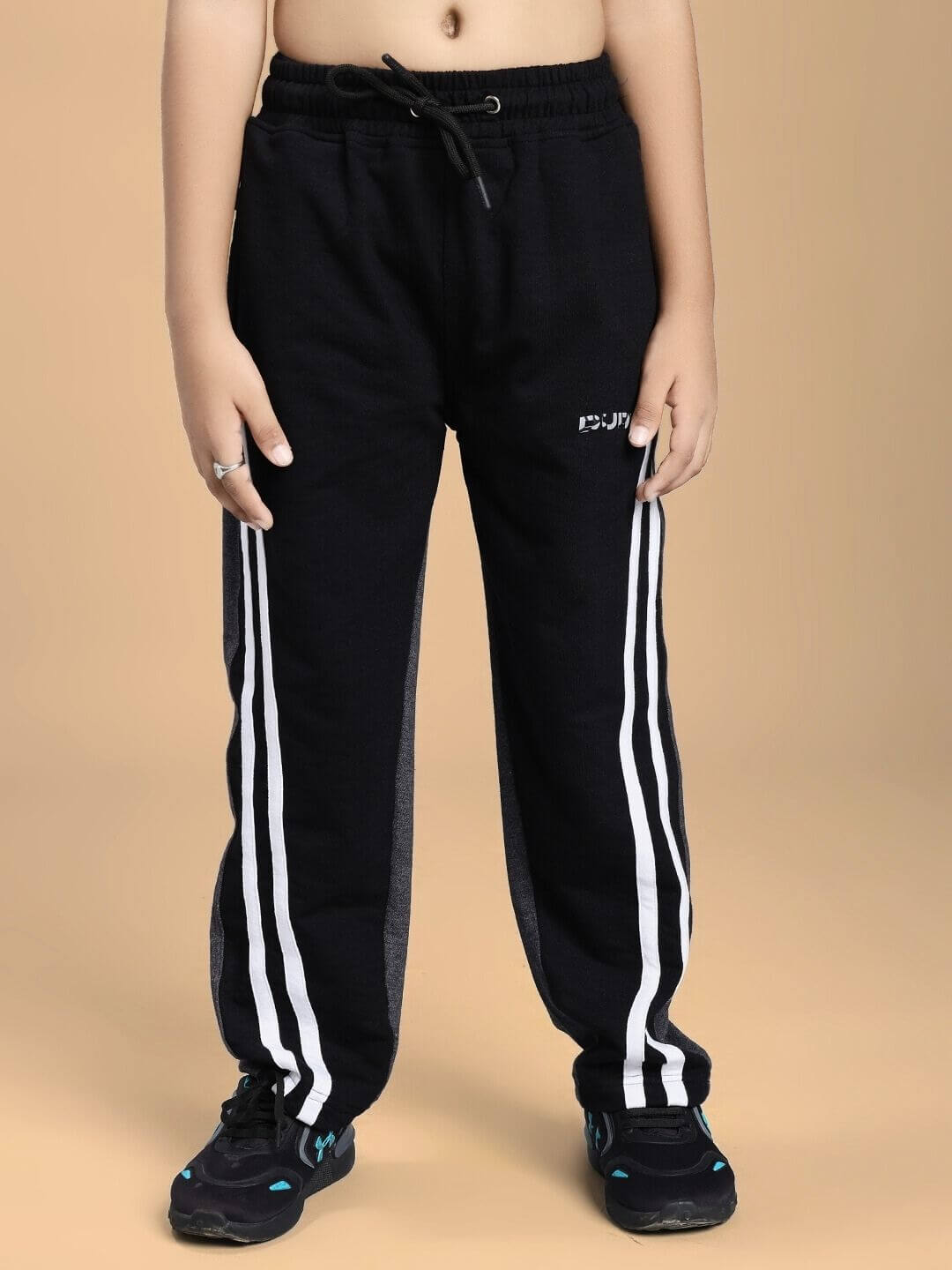 Child wearing BOSCO STRIPE JOGGER FOR BOYS AND GIRLS BLACK DARK GREY with white stripes, showcasing comfy and stylish design for active kids.
