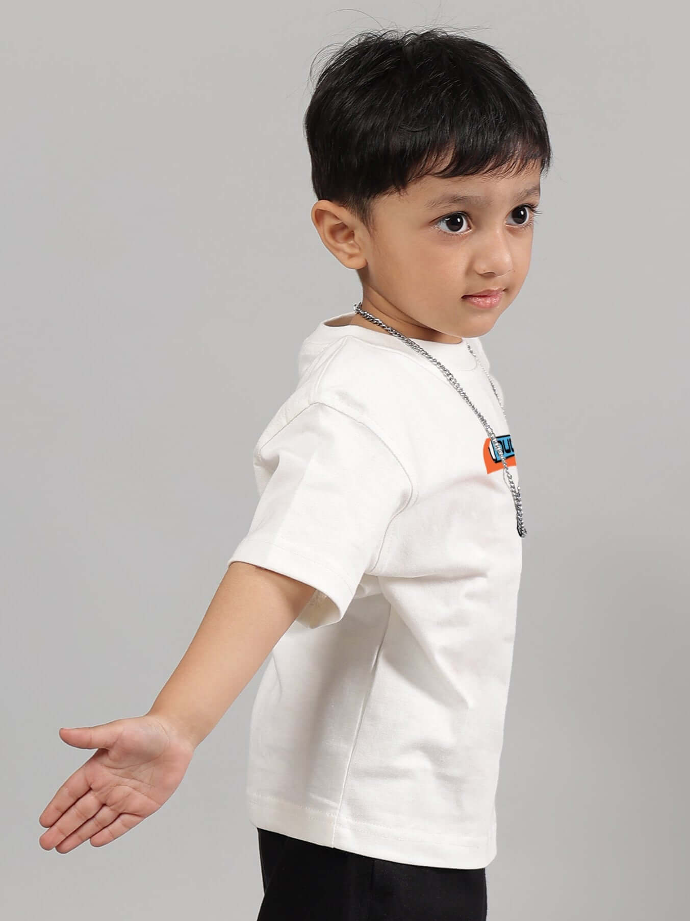Child wearing a white Robo Shark t-shirt for boys and girls by DUDS.