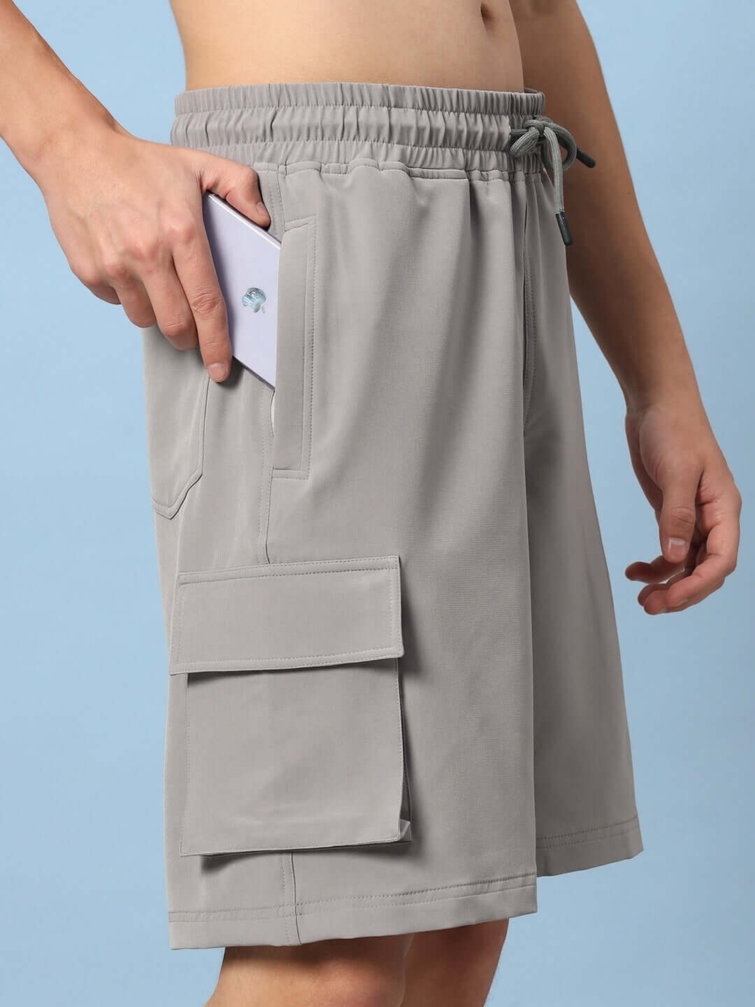 Brawny cargo shorts in grey with pockets, featuring elastic waistband; option for custom fit available for prepaid orders.